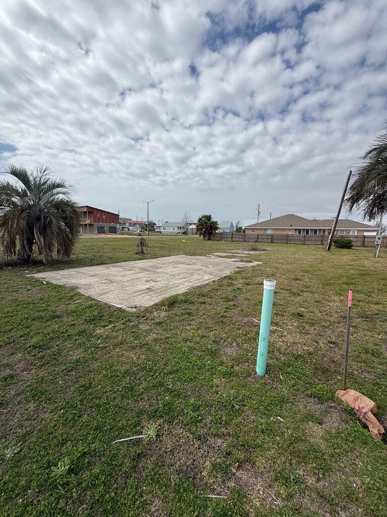 Corner lot located approximately 800 feet from the beautiful, sugar white sands beach with dedicated public access. This X flood zone lot was a former homesite and already has water and sewer taps paid. There are also some established palm trees, an existing driveway, and electric stub out. Many options for building as the X flood zone designation allows one to build on grade if desired. Quiet neighborhood with a nice boulevard (Florida Ave) for added privacy. Priced to sell and will not last long.