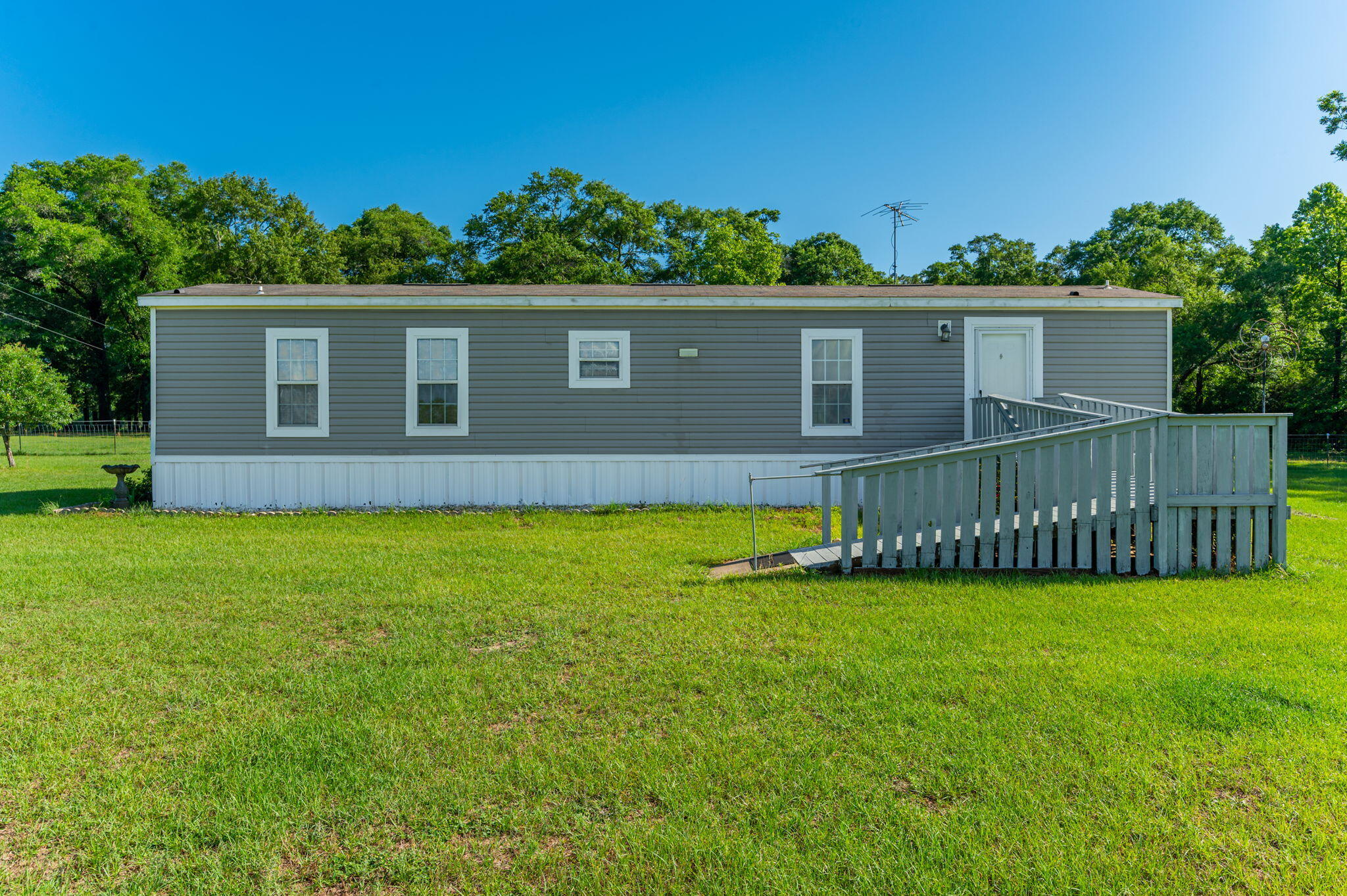 This charming home offers peaceful country living with beautiful views of the surrounding landscape. With 2 bedrooms and 2 bathrooms, the layout is both comfortable and functional. The open living area is filled with natural light, creating a warm and inviting space to relax or entertain. The kitchen provides ample cabinet space and blends perfectly with the home's cozy, rural character. Nestled in a quiet area, the property offers a slower pace and a deeper connection to nature, all while remaining within a reasonable distance of local amenities. Come experience the tranquility and charm of this countryside retreat—contact us today to schedule your showing.
