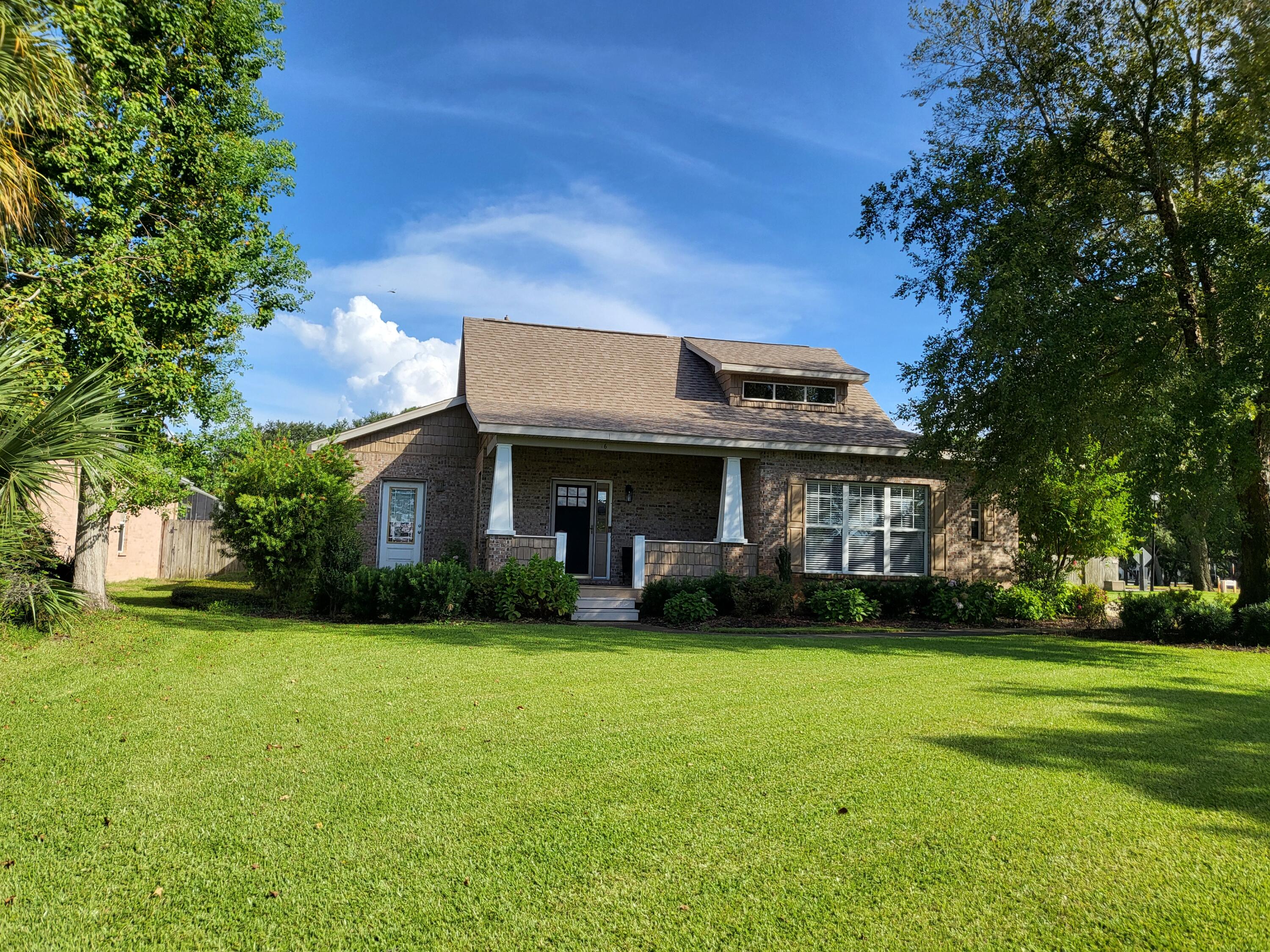 A true Craftsman style custom home. LVP floors throughout the entire home.  $93,000 of paid off solar panels was installed in 2020.  Reroof was done at the same time as solar panels. Professional landscaping was completely replaced in 2024 along with irrigation system and lawn pump on timers. The fenced back yard boasts newer horizontal fencing, heated swimming pool &spa with waterfall, and plenty of patio space. From the cozy front porch, with sunset views across Garnier's Bayou, you enter into the massive living room with 22' ceilings, a beautiful custom staircase, and Craftsman columns. The living area opens into the dining room and kitchen for a grand space to entertain. The dining room has crown molding and custom walnut panels on lower half of walls.  The open sunken kitchen has abundant counter space in addition to an island with sink, 2-drawer dishwasher and bar seating. Custom Craftsman kitchen cabinets have beadboard inserts in doors.  Stainless steel gas stove, new in 2024, built-in microwave, and French door SS refrigerator. Adjacent to the kitchen is a ''butler's pantry'' with more cabinets, a prep sink & disposal, a second stove (electric) and another refrigerator, both new in 2026. It connects to a laundry room with more cabinets. A set of French doors leads into a second living area with large windows facing the morning sun. The primary bedroom suite is spacious and will accommodate large furniture. A second bedroom/office and bathroom complete the first floor The open Craftsman style staircase leads to a guest suite on the second floor with ensuite bathroom, skylights, and a small loft featuring a triple dormer with views across the bayou. HVAC & a gas tankless water heater are located in the "attic" space on the 2nd floor. A 2 car garage, with a 3rd bay for workshop/craft area completes the property. Two separate driveways offer parking for up to 10 cars for those family gatherings. This home is full of warmth and unique design.