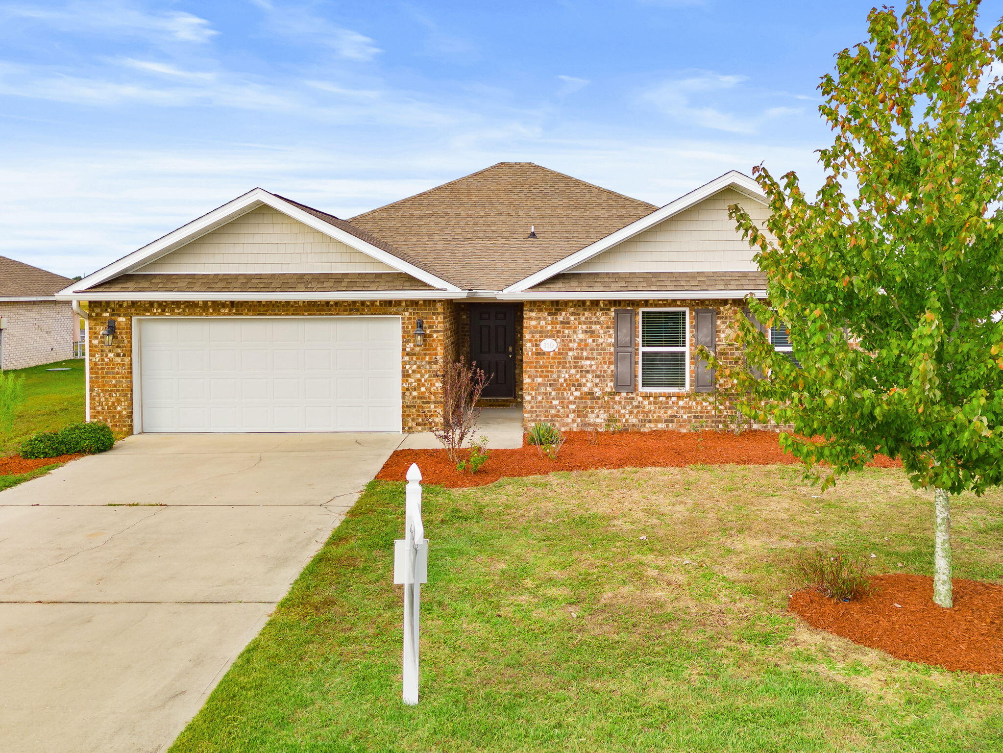 Welcome home to this beautifully designed 4-bedroom, 2-bath brick home in a gated Southport community near Deer Point Lake and public boat access. The open-concept layout features luxury vinyl plank flooring, recessed lighting, and a spacious living area flowing into a kitchen with granite countertops, tile backsplash, stainless steel appliances, and a large island. The split-bedroom design offers privacy for the primary suite with double vanity, walk-in closet, soaking tub, and separate shower. Enjoy a covered patio, fenced backyard, shed, and outdoor shower. Convenient to Hwy 77, Panama City, Lynn Haven, and local schools.