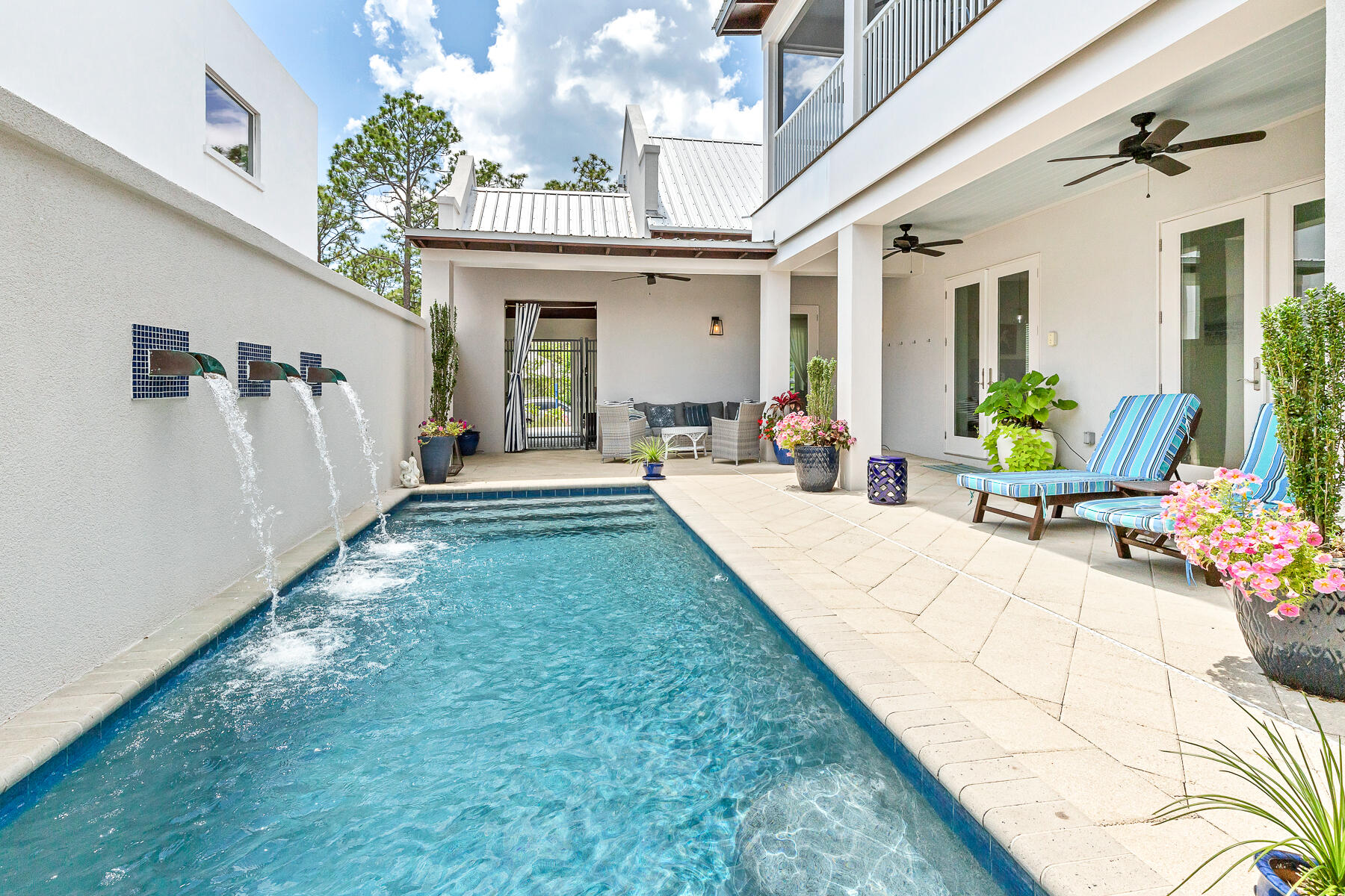 Deeded beach access and use! Alys Beach inspired concrete home in the heart of Seagrove. This 4 bedroom home is located just off 30A in Gulf Shore Manor that boasts deeded beach access and use. The moment you pass through the portico, the home unfolds into a sanctuary designed for seamless indoor-outdoor living. The central hub is anchored by natural light filled great room, where 18-foot cathedral ceilings are accented by local cypress beams. Three sets of oversized doors disappear to invite the coastal breeze inside. This beach home was created to enjoy a fluid connection to the private courtyard and heated saltwater pool. 

The chef's kitchen is fully equipped with dual dishwashers, double sinks, a new gas range, and a large island that serves as the natural gathering spot. The primary suite, located on the main level, feels like a boutique resort wing. It features expansive dual walk-in closets, a spa-like shower with double heads, and direct pool access, allowing you to wake up to views of the water feature every morning. A second bedroom is located on main floor with easy access to the outdoor living area. 

The private oasis includes a tranquil water feature and a tucked-away summer kitchen--complete with a grill, refrigerator, and sink--perfect for poolside dining. Upstairs, a large screened porch overlooking a view of the pool sanctuary, providing a peaceful escape for morning coffee or evening cocktails. With two additional oversized bedrooms featuring built-in bunks, the home is thoughtfully scaled to accommodate guests with ease.

Located on a low-density street with a 15 foot buffer on one side, this property offers a sense of seclusion while being moments from the energy of Seaside (1.3 mile to the west) and WaterColor (less than 2 miles). Owners and guests enjoy over 1,400 feet of deeded beach access at the end of the street, making it easy to transition from the pool to the emerald waters of the Gulf. Offered fully furnished and including a street-legal LSV, this turnkey property is an exceptional opportunity for full time residence,  a second home, high-performing investment with established bookings already in place. Also within a short distance is regional beach access with seasonal lifeguards, ramp to the beach, restrooms and plenty of parking. Other walkable neighborhood beach access include Dothan, San Juan, Montigo and Pelayo offering plenty of options to enjoy the white sandy beaches of 30A.  Rental projections over $150k!