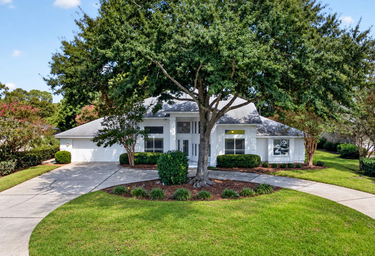 Set on a beautiful nearly .4 acre lot in Bluewater Bay, this spacious 3423 sq ft, 4-bedroom, 4-bath home offers abundant natural light, generously sized rooms and flexible living spaces with truly unique details. The oversized primary suite provides a comfortable retreat, while the generously sized bedrooms offer plenty of room for family and guests. Extended living areas provide additional space for entertaining, relaxing, a home office or hobbies, with even more versatile living space upstairs. A screened-in room provides a wonderful place to relax and enjoy the Florida lifestyle.
Adding to the home's one-of-a-kind character are special panda-themed details, including a custom stained-glass panda window and other unique touches that have become part of the home's story and identity. Thoughtful features and updates include a Kohler whole-house generator, hurricane shutters, epoxy-coated garage flooring, a new water heater in 2026, two 2019 HVAC units, and new roof in 2016. Mature landscaping, a spacious yard and low HOA dues add to the appeal.  Conveniently located in Bluewater Bay, the home offers easy access to Destin's beautiful beaches, dining, shopping and entertainment, while also providing convenient proximity to Eglin Air Force Base.