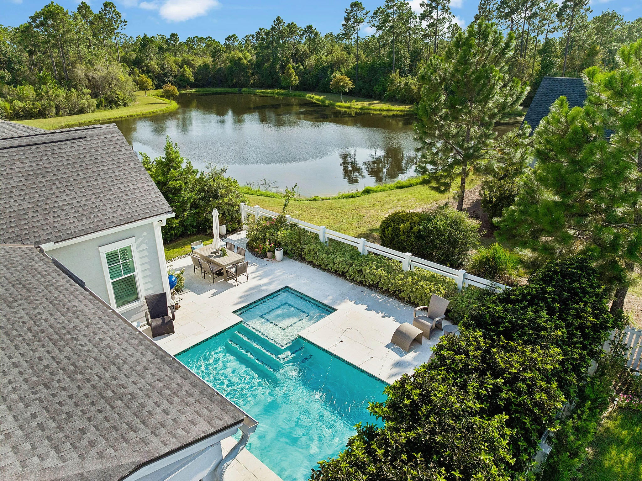 A private pool, lake views and beautifully landscaped backyard set the tone for this Romair-built Eliot plan in Watersound Origins. Designed for easy indoor-outdoor living, the light-filled great room connects to the screened porch through an impressive 16-foot wall of sliding glass doors, extending the living space toward the pool and framing views of the lake beyond.

Outside, the custom pool is positioned to take advantage of sunset views over the lake and features a sun shelf, bubbler and fountains, with pool features conveniently controlled remotely. A custom lighting system offers single- and multi-color options, fading color blends and programmable lighting sequences for evenings outdoors. Upgraded pavers create a generous pool deck for lounging and entertaining, while extensive landscaping and mature hedges add privacy without sacrificing the lake view.

Inside, a light and airy aesthetic is complemented by beautiful white oak flooring throughout the main living areas. The open kitchen features quartz countertops, soft-close cabinetry and drawers, Bosch stainless steel appliances and a gas range, with a spacious layout that keeps the kitchen connected to the main living and dining spaces.
 The Eliot offers three bedrooms and three full baths, including a spacious primary suite and a secondary primary suite, providing an especially comfortable setup for overnight guests or extended stays. The bathrooms are finished with Carrara marble countertops, with porcelain tile adding another elevated detail in the primary bath. Carrara marble also carries into the laundry room, giving the home's utility spaces the same attention to finish as its main living areas.

A two-car garage, screened rear porch and carefully considered upgrades round out the home. Used only as a second residence and very lightly lived in, the property has been exceptionally well maintained. With its custom pool, private outdoor space, sunset and lake views, and bright interiors, this home brings together some of the best elements of the Watersound Origins lifestyle.

Watersound Origins offers a thoughtfully planned lifestyle surrounded by the natural beauty of Northwest Florida, with miles of walking and biking trails, parks and green spaces woven throughout the community. Residents enjoy access to the Village Commons pool and fitness center, sports courts, Lake Powell and the Origins Golf Course, along with neighborhood events and gathering spaces. Nearby Watersound Town Center adds Publix, restaurants, shopping, healthcare and everyday conveniences, while the beaches, dining and communities of 30A are just minutes away.