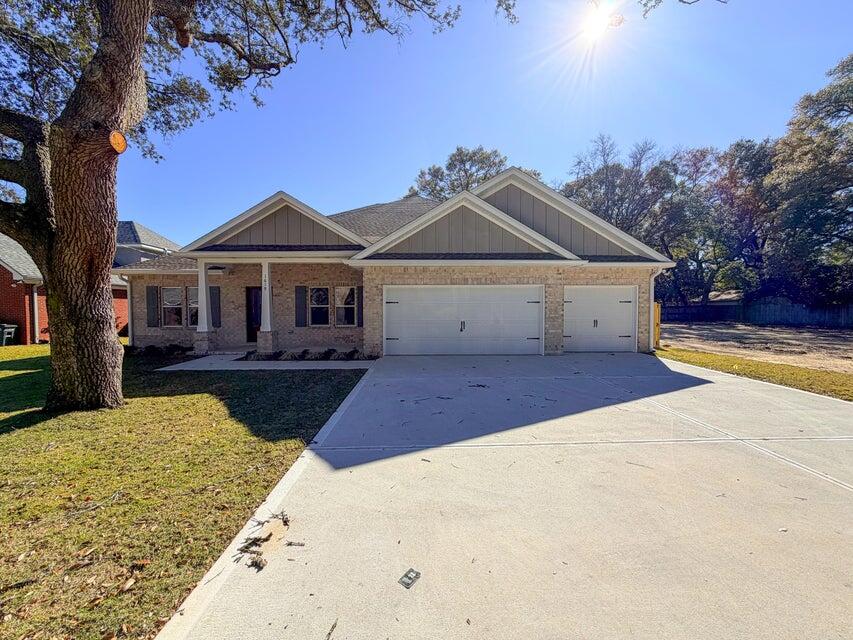*Estimated Completion Date of October 30th.* This stunning brand-new Craftsman-style residence in the heart of Niceville offers a rare combination of modern luxury and turn-key convenience. Photos are of a similar floor plan. Finishes & some details depicted may not be the same. Boasting five spacious bedrooms and three full bathrooms across a thoughtfully designed 2,656-square-foot layout, this home is engineered for both sophisticated entertaining and comfortable daily living. The heart of the home is a chef-inspired kitchen featuring premium quartz countertops, a professional gas range, custom soft-close cabinetry, and a deep farmhouse sink, all centered around a functional island and a massive walk-in pantry. High-end luxury vinyl plank flooring flows seamlessly through the main living areas, accented by elegant crown molding and soaring vaulted and tray ceilings that enhance the home's open, airy feel. The split-bedroom floor plan ensures maximum privacy for the primary suite, which serves as a true retreat with its spa-like garden tub and dual-vanity bath. Efficiency and safety are paramount, with the inclusion of a tankless gas water heater, natural gas heating, impact-rated windows, and a full sprinkler system. Outside, the oversized three-car garage provides ample space for vehicles, a boat, or a workshop, while the level backyard offers a secure oasis for relaxation. Situated in the top-rated Plew, Ruckel, and Niceville High school districts, this home is just minutes from Eglin AFB and the white-sand beaches of the Emerald Coast.
*Fence, blinds, and fridge included with acceptable offer and must be included in additional terms.*Builder incentives MUST be included in contract*