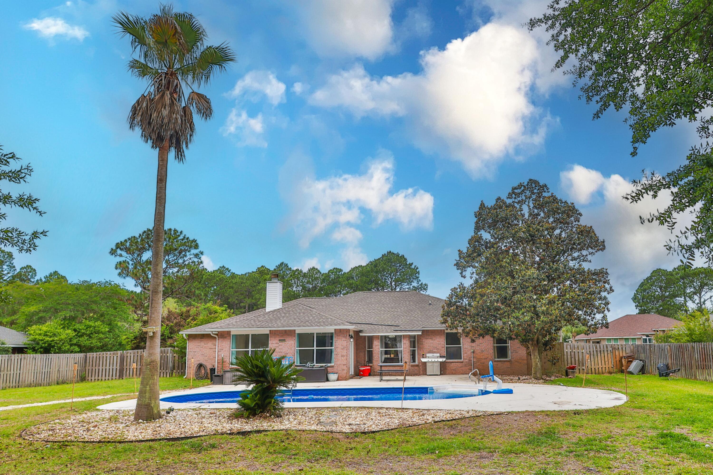 Welcome to your own private oasis in the highly sought-after Holley by the Sea community! This spacious 4-bedroom, 2-bath home offers 2,200+ square feet of comfortable living space on an oversized .64-acre lot designed for both relaxation and fun.

Step inside to discover new flooring throughout most of the home, a formal dining area perfect for entertaining, and a bright sunroom that overlooks the incredible backyard retreat. Outside, the possibilities are endless: enjoy the in-ground pool complete with a protective safety fence, gather around the fire pit on cool evenings, or take advantage of the ultimate family-friendly backyard featuring a kids' play area, swings, and even a zip line!

The beautifully landscaped front yard creates welcoming curb appeal, while the long driveway and 2-car garage provide plenty of parking space for guests, boats, or extra vehicles. Sleep easy knowing a new hot water tank & roof were replaced in 2020, gutters were installed in 2021, the pool liner was replaced in 2022, new HVAC in 2023, a new pool pump and new sand in the pool filter in 2025! 

Whether you're hosting pool parties, enjoying peaceful evenings outdoors, or simply soaking in the Florida lifestyle, this property truly has it all. Located in the desirable Navarre area with access to the amenities of Holley by the Sea, this home combines space, comfort, and outdoor living in one unforgettable package.