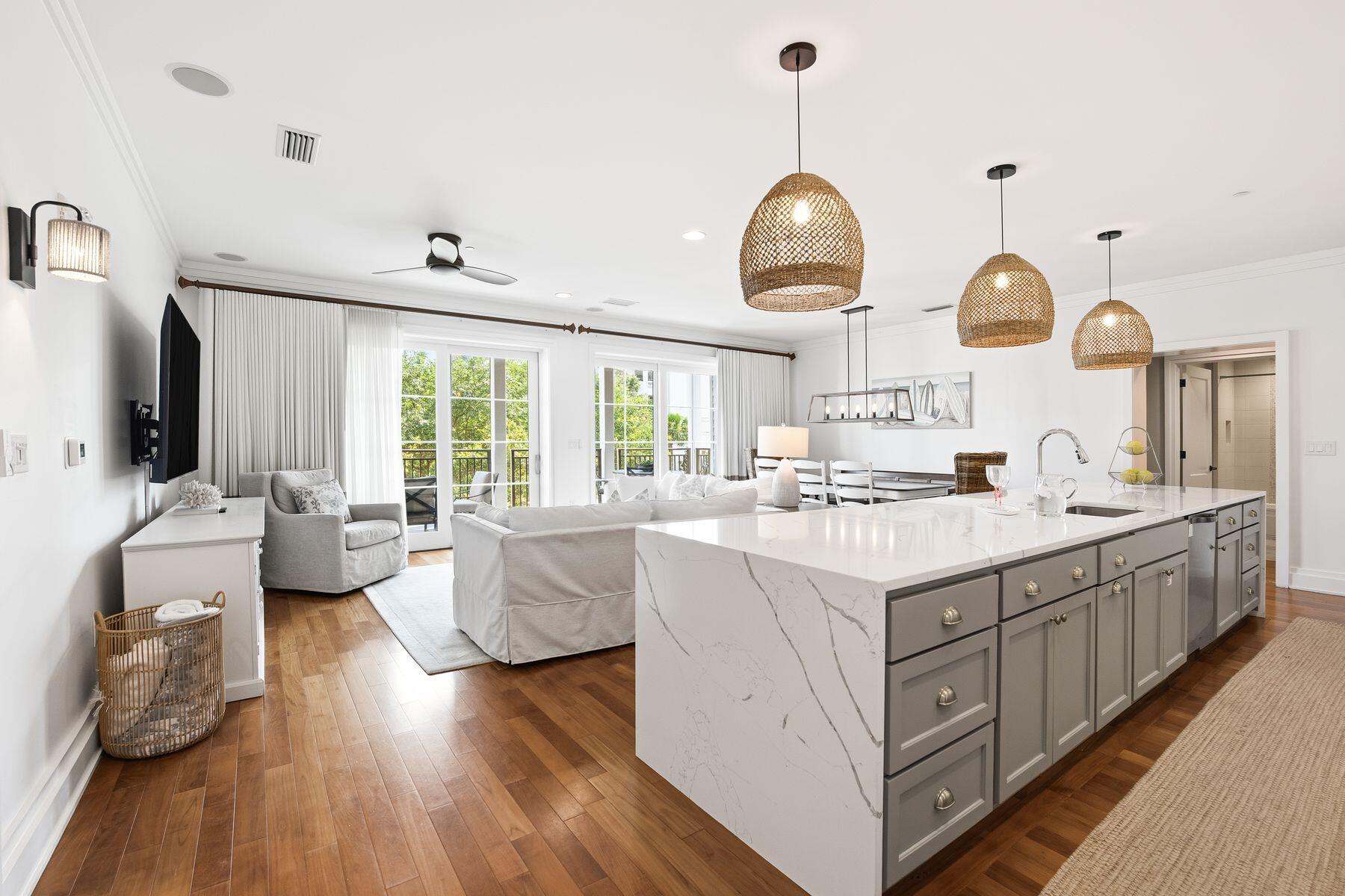 Positioned along Scenic Highway 30A, this beautifully appointed residence offers an exceptional opportunity to enjoy the coastal lifestyle in one of the area's most exclusive low-density condominium communities. With only 17 residences, this boutique retreat combines outstanding privacy, refined finishes and resort-inspired amenities, all within moments of the area's renowned dining, shopping and beaches.

Designed for effortless living and entertaining, the spacious open-concept floor plan flows seamlessly from the kitchen into the dining and living areas, before extending onto an expansive covered balcony.

The thoughtfully designed kitchen serves as the centerpiece of the home, featuring a striking waterfall-edge quartz island, custom vent hood, premium appliances and abundant workspace. Hardwood flooring carries throughout the main living areas, while three generously sized bedrooms and three full bathrooms comfortably accommodate family and guests. A custom-built bunk room adds flexibility for additional sleeping arrangements and the full-size laundry room with extra storage enhances everyday convenience. An additional private owner storage unit is also included. The community's recently completed exterior restoration, along with updated fitness facilities and pool amenities, provides peace of mind and a fresh, contemporary appearance. Residents enjoy access to an impressive rooftop terrace featuring a heated pool, bubbling spa, grilling stations and panoramic Gulf views, creating an exceptional setting for relaxing or entertaining. Additional amenities include a state-of-the-art fitness center with a steam room and sauna, an elegant owners' lounge with a catering kitchen, elevator access, and the convenience of WaterHouse Provisions & Bottle Shop located on the ground floor.

Sold fully furnished and currently operating as a successful vacation rental with future bookings already in place, this turnkey residence presents an outstanding opportunity as a primary home, second residence or investment property in one of 30A's most desirable locations.
