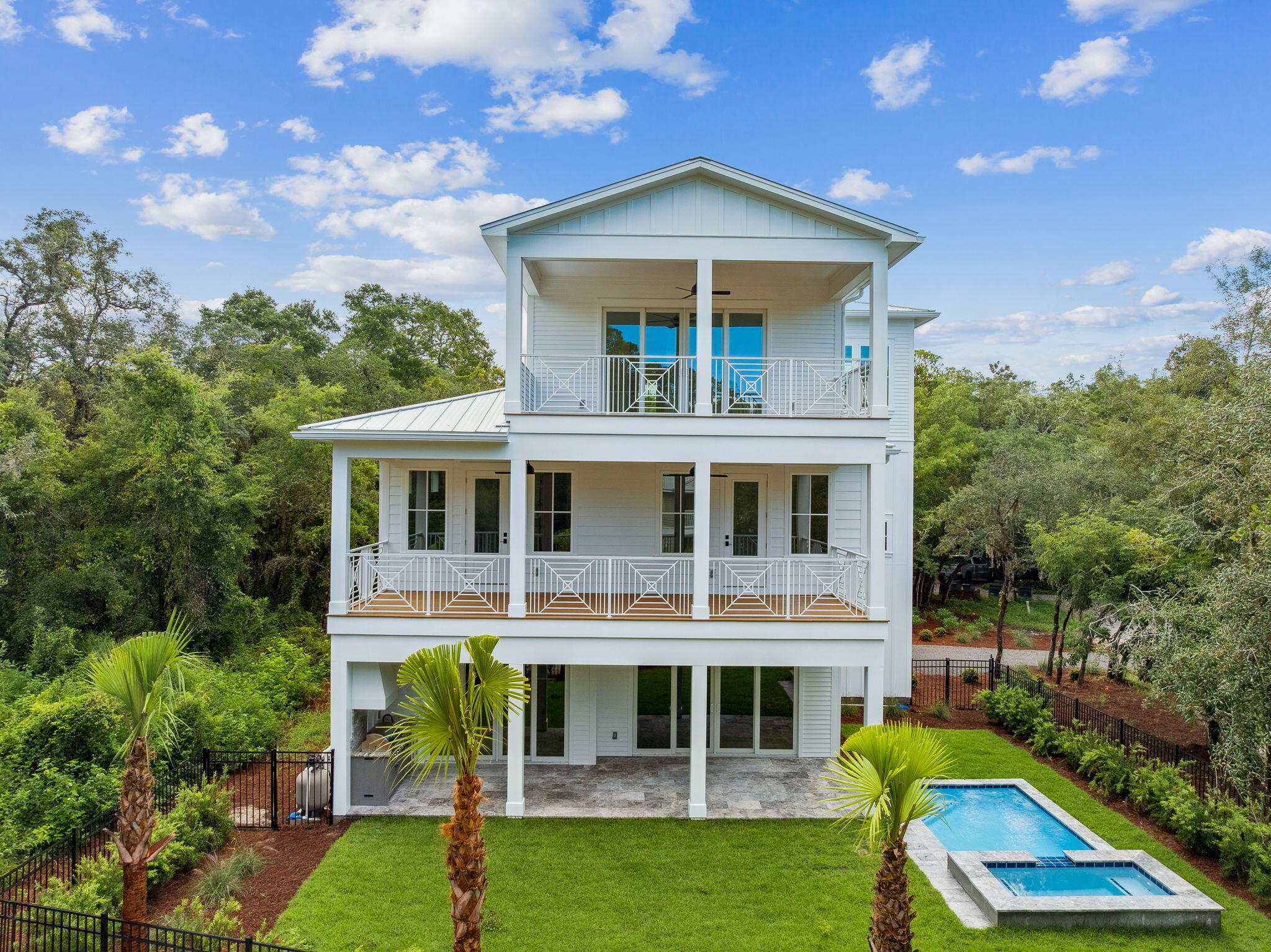 Nestled on a coveted private road in the heart of Grayton Beach, 86 Grayton Trails is a stunning new-construction residence designed by the talented team at Foresight Design and built by CM Taylor Construction. Grayton Trails Road offers mature century-old oaks, shady magnolias, and towering pines, creating a dense canopy and arguably one of the most serene settings on all of Scenic Highway 30A. Completed in August of 2025, this home encompasses 4,460 sq ft of heated and cooled living space, including 7 bedrooms, 7 full bathrooms, and 1 half-bathroom. Ten-foot ceilings and an abundance of natural light add to the home's sense of spaciousness. A private pool & spa, large fenced-in yard, outdoor kitchen, and 2-car garage add to the home's appeal. Upon entry, the home opens into an expansive living, kitchen, and dining area - large enough to host multiple families at a dinner party. The living area is accented by a red queen brick wall with a built-in gas fireplace. The kitchen features high-end Subzero and Wolfe appliances, a generous 4'x10' island with a large farmhouse sink, custom cabinetry, and a walk-in pantry with bonus storage area. This floor has one oversized bedroom with an ensuite bathroom. From the living/dining area, sliding glass doors reveal the fenced-in backyard, a heated pool and hot tub, summer kitchen, and additional covered outdoor living and dining areas.

An extra-wide staircase leads to the second floor, showcasing the primary bedroom suite,  along with three additional bedrooms, each with their own bathrooms and shared balconies. The primary suite features accented lighting, two closets, a roomy double vanity, and a dedicated shower area with a soaking tubThe laundry closet, with 2 sets of LG washer/dryers, is on this floor.

The third level offers an additional living/bonus area with a wet bar and mini fridge. This floor is complete with a 6th bedroom with an ensuite bathroom and a twin-over-twin bunk room and bathroom.

Situated on a generous .33 acre lot, this beautiful beach compound offers a large driveway and an enclosed two-car garage, a rare and welcomed amenity for any home on 30A, but especially for Grayton Beach. The entire 1/3 acre lot falls in Flood Zone X where flood insurance is not required.