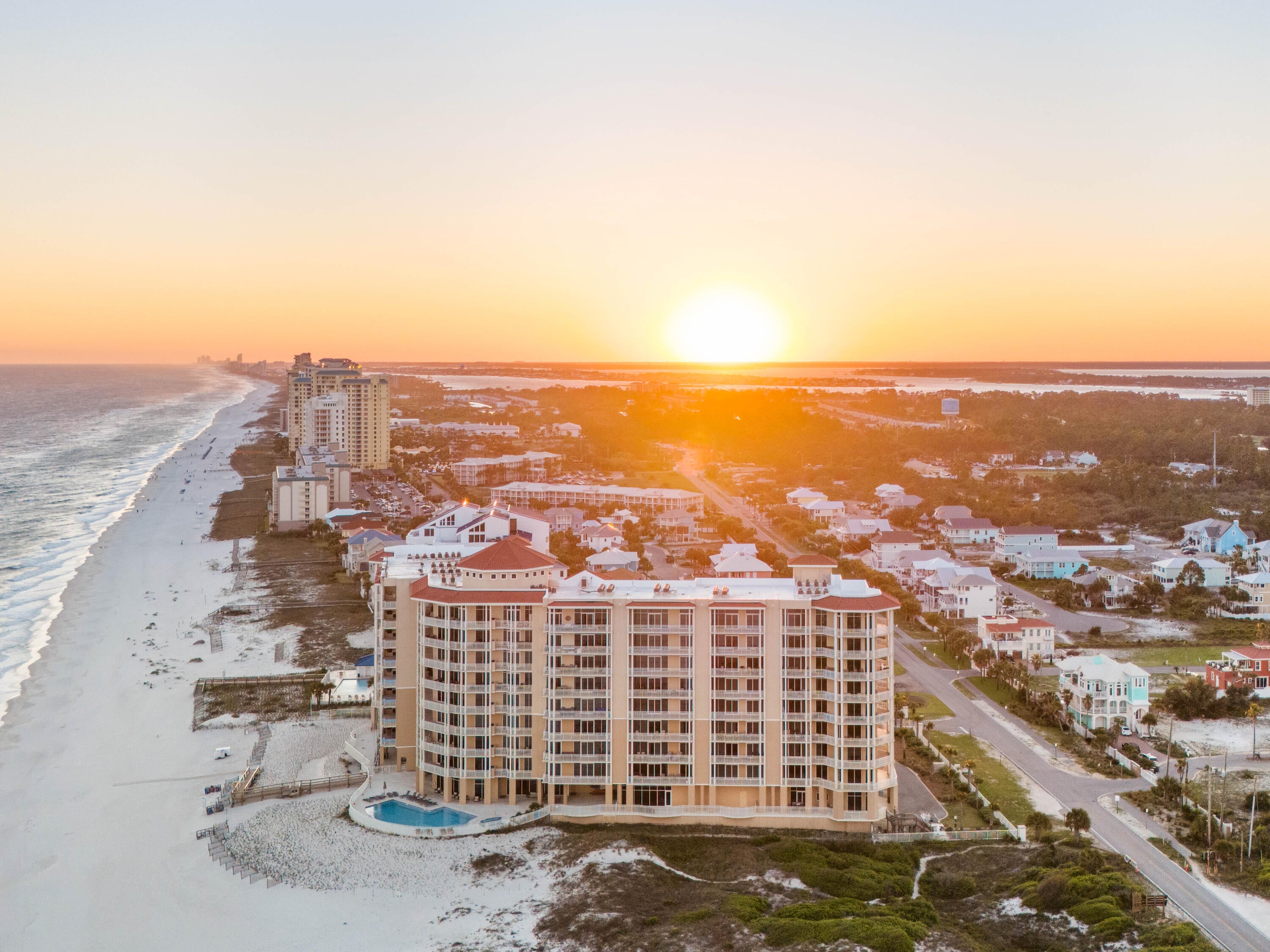 Unparalleled Gulf views define this luxury 3-bedroom, 3.5-bath condo in one of Perdido Key's premier Gulf-front communities, ideally located alongside 5.5 miles of pristine Gulf Islands National Seashore. With only 64 Residence at Vista Del Mar, you have the rare opportunity to enjoy secluded beaches & impressive interiors. The residence offers a contemporary open floor plan to enjoy perfect picturesque views from every angle & floor to ceiling glass. The large, deep balcony provides the best spot for outdoor entertaining, dolphin watching & sunsets, and it features a gas grill installed. Let the elegant plank ceramic tile flooring guide you through main living areas of this beach abode that is filled with natural light. Luxury quartz countertops & high-quality cabinetry enhance the aesthetics of this chic condo. The gourmet kitchen offers a modern design, with state-of-the-art appliances including a Wolf range & hood & Sub-Zero refrigerator. A separate dining area & wet bar complement the space, equipped with sink, wine fridge & ice maker. Each bedroom is its own sanctuary, & the primary bedroom with en suite is its own lavish living experience - providing balcony access & adorned with an expansive closet, soaking tub & separate solid glass, frameless shower. Bonus features are assigned covered parking #34 & assigned climate-controlled storage space #S58 plus a storage closet on balcony.  The secured, gated community has many unique features including a beautiful grand lobby with multiple seating areas and unbeatable views of the Gulf. A club room with bar, pool tables, & televisions enhances the complex with extra entertainment options. You will be sure to appreciate the best of amenities to include an indoor heated pool, owners' health club with fully equipped fitness room, massage treatments rooms, kid's club & much more. Its the best of the beach!