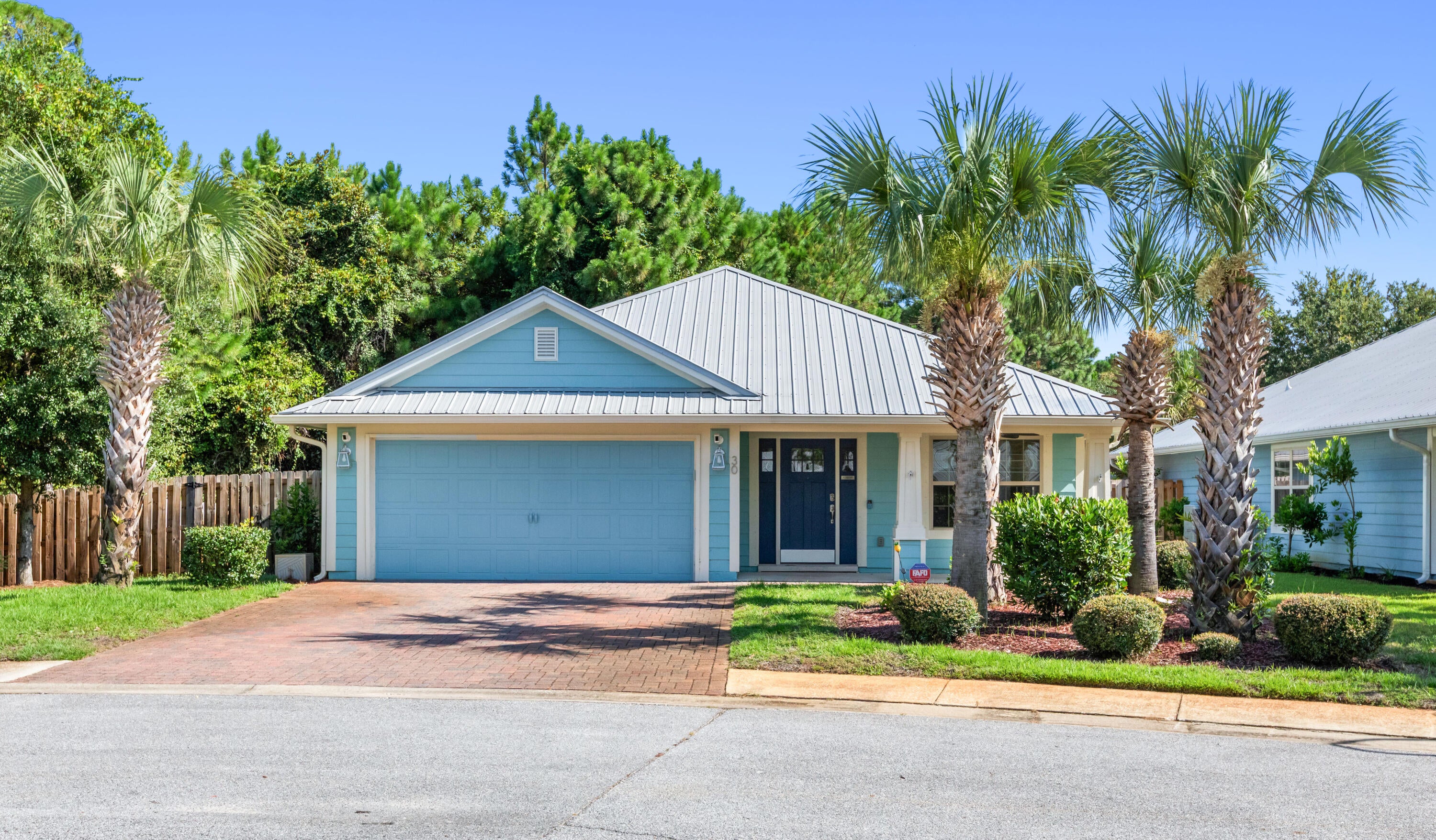 Tucked away in the desirable neighborhood of Eagle Bay, this home boasts 2 great sized living spaces and 3 bedrooms. The master bedroom has a large walk-in closet and fully upgraded master bath. Kitchen is complete with a breakfast bar, stainless steel appliances, Granite counters and a separate pantry. Wood Flooring, tile and carpet throughout. This gem comes with a beautiful, paved driveway, metal roof, sprinkler system, large front porch, and extra storage in the attic. Socialize outside on your large patio and enjoy a natural backdrop that is protected. Fully fenced in yard with a large side yard and gate. Come join this family friendly neighborhood just steps away from the Bay and a short 5-minute drive to the beautiful beaches of 30A on the Gulf of America!!