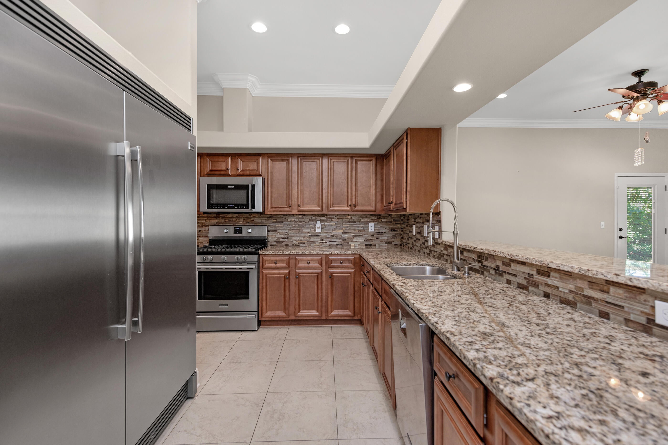 Some homes simply check the boxes. Others make you immediately picture your life there.

Pull up to 116 Wellington Road and you get that feeling right away. The brick exterior, welcoming front porch, and quiet residential setting create the kind of first impression that feels established, comfortable, and easy to come home to. Step inside, and the home opens into a thoughtfully designed one-story layout where everyday living feels effortless.
The heart of the home is the spacious great room. Raised ceilings, crown molding, recessed lighting, and hardwood floors create an inviting setting for everything from slow mornings with coffee to evenings gathered with family and friends. There is room to spread out without losing that comfortable sense of connection.

Move into the kitchen and you'll find a space designed for someone who actually enjoys being at home. The gas range, granite countertops, maple cabinetry, stainless appliances, breakfast bar, and pantry provide both the style and functionality needed for everyday meals or entertaining. The natural flow between the kitchen, dining area, and great room means the cook never has to miss the conversation. When the day winds down, the primary suite offers a quieter place to retreat. The spacious bedroom provides plenty of room to create your own comfortable sanctuary, while the private bath features a double vanity, garden tub, separate shower, and walk-in closet. The split-bedroom design gives additional rooms their own sense of privacy, making the home equally suited for a growing household, guests, a home office, or whatever life calls for next.
Then step outside.

The covered patio leads to a privacy-fenced backyard that gives you something increasingly valuable -- your own outdoor space. Picture weekend barbecues, kids or pets playing in the yard, or simply sitting outside at the end of the day while enjoying a little fresh air. The irrigation system and lawn pump help make maintaining the yard easier, while the covered patio gives you another place to enjoy it.

The home's practical features are just as appealing as its aesthetics. A two-car attached garage provides everyday convenience, while natural gas, a tankless gas water heater, central air, double-pane windows, and a functional laundry area add comfort and efficiency to the daily routine.
And then there's the location.

Set within Colonial Estates in the Ocean City area of Fort Walton Beach, 116 Wellington Road offers a convenient home base for enjoying everything the area has to offer. The property is positioned off Eglin Parkway with access toward the surrounding Fort Walton Beach community, while the broader area is closely connected to both Eglin Air Force Base and Hurlburt Field, making it especially appealing for military families, defense professionals, and others who want to stay connected to the region's major employment centers.

The neighborhood itself offers the feeling of an established residential community rather than a home tucked away from everything. Daily conveniences, schools, shopping, dining, and the beaches and attractions of the Emerald Coast are all part of the lifestyle that comes with calling Fort Walton Beach home.
Maybe you're relocating to the area and want a home that feels comfortable from the moment you arrive. Maybe you're looking for a one-story layout that gives everyone their own space without unnecessary stairs. Or maybe you've simply reached the point where you want a home that feels finished, functional, and easy to enjoy.

Walk through the front door and imagine your mornings in the kitchen. Picture dinner conversations flowing into the great room. Imagine opening the back door on a beautiful Florida afternoon and stepping onto the covered patio. Think about having a private backyard, a comfortable primary suite, a practical garage, and a home designed around the way people actually live.

116 Wellington Road isn't just a place to live. It's a place to settle in, make it your own, and enjoy the everyday lifestyle that makes Fort Walton Beach such a special place to call home.