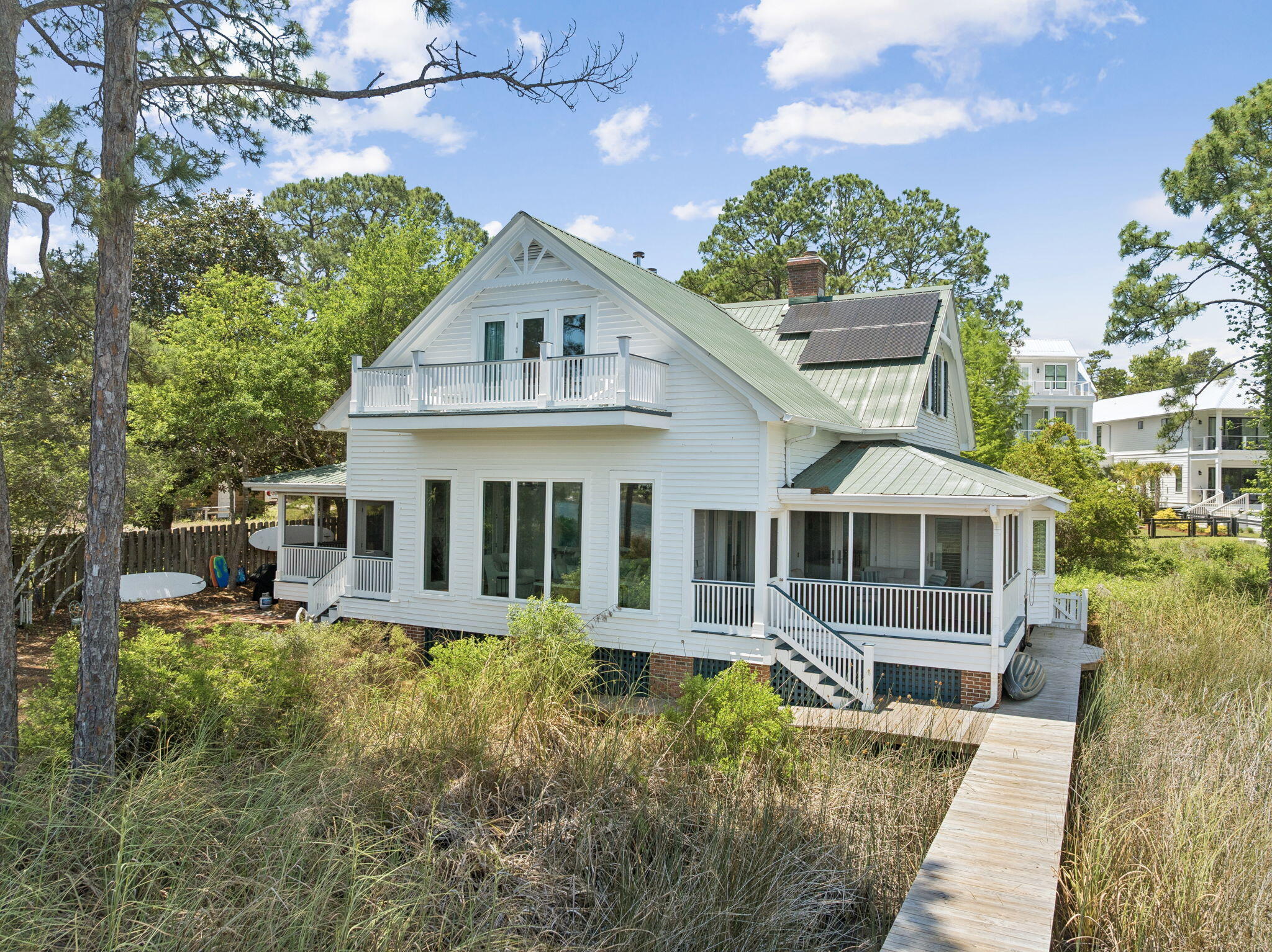 Positioned directly on Eastern Lake, one of Florida's rare and protected coastal dune lakes creates the perfect trifecta: EASTERN LAKE frontage + private dock + GULF views in from 2nd floor. 
This 4BR/4BA property offers a lifestyle that's virtually impossible to find on the market today: private waterfront, a private dock for kayaking straight to the beach, an oversized homesite, and true walkability to the GULF.

 The home itself is considered a generational home 'the one to pass down'that is unique to our area. Thoughtfully renovated to blend modern comfort with timeless coastal architecture, it features 13-foot ceilings, heart-of-pine floors, multiple fireplaces, and mature landscaping that gives the property a settled, established feel new construction can't replicate. With 4 bedrooms, 4 bathrooms, and two primary suites (one on the main level, one upstairs), plus nearly 3,000 square feet of living space, the layout offers flexibility for multi-generational living, guests, or a second-home retreat. Multiple porches and decks extend the living space outdoors, framing nonstop views of Eastern Lake from nearly every angle.
Whether as a primary residence, second home, or investment, this is a once-in-a-generation opportunity to own an irreplaceable setting: private lake frontage, dock access, walk-to-beach convenience, and room to expand -- all in one of 30A's most sought-after communities. It includes CONCRETE FOUNDATION PIERS to allow water to flow freely under the house This home can easily reach the beach from its dock or walking on the street. Very private setting and yet close to the beach and shopping and restaurants.