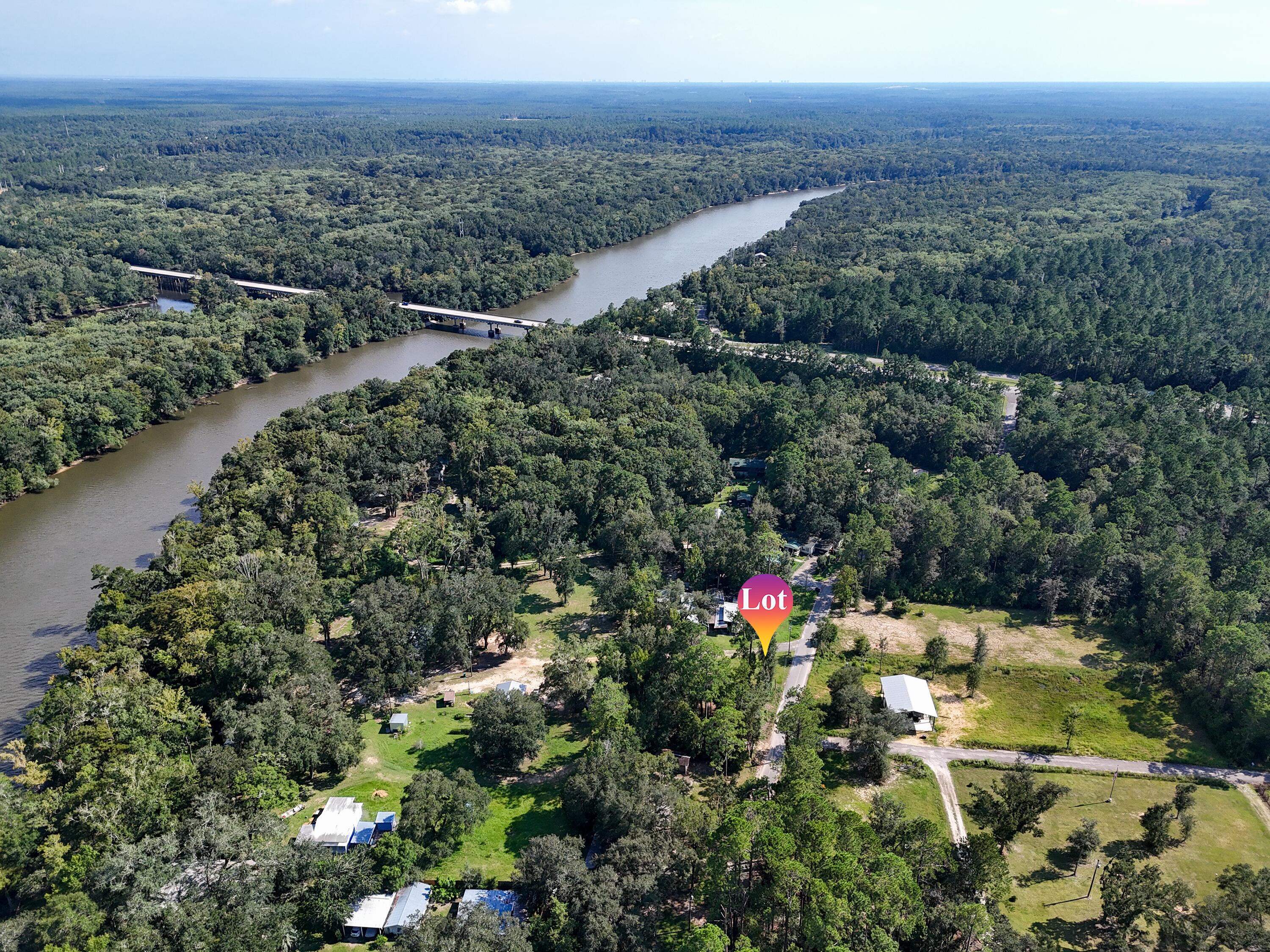 Ebro Florida lot blocks from River! Come take a look at this vacant lot just minutes to Cowford Boat launch and landing that allows you to launch straight into the Choctawhatchee River! This is a very quiet location, No HOA, and only minutes from Panama City and Freeport. This lot offers you the opportunity to build whatever your heart desires rather it is a weekend getaway of a place to retire. Lot offers a septic in place and includes a power pole. Lot has plenty of room for your water toys! Come take a look at this rare chance to own a vacant parcel lot in peaceful Ebro, Florida!