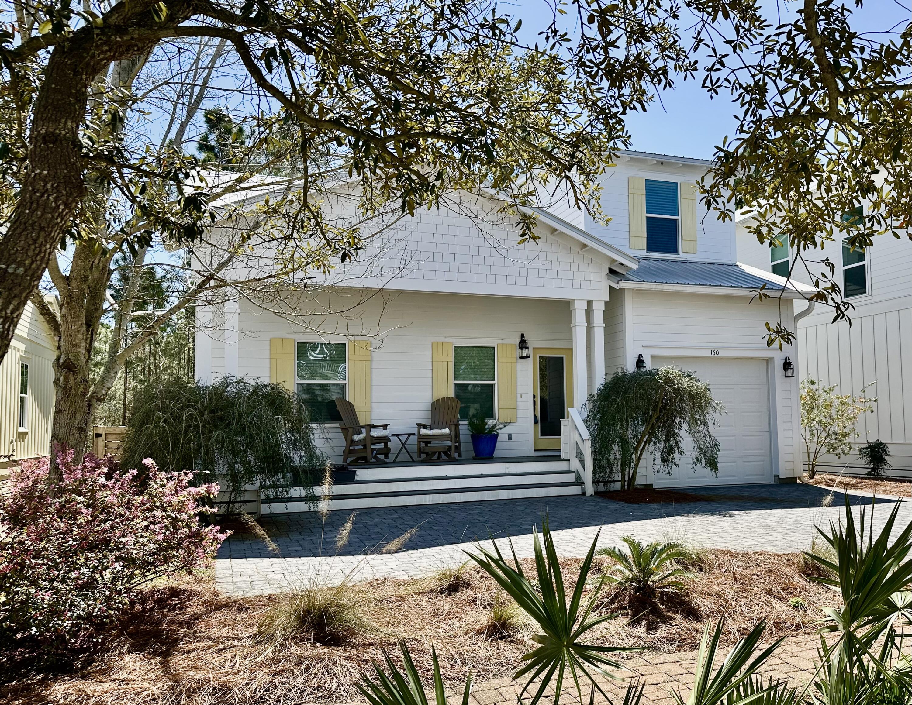 Tucked away in the gated community of Hidden Grove, this coastal cottage backs up to a state nature preserve.  An expansive deck along the entire rear of the home, provides a wonderfully private venue to enjoy the outdoors. The home is appointed with granite counter tops throughout, hardwood floors in the living, dining, and kitchen areas as well as the downstairs master bedroom.  Upstairs, the three bedrooms and loft area are carpeted.  Master bath and other two bathrooms have tile flooring.  The downstairs master has two closets, and the adjoining bathroom has two vanities, a garden tub, and separate shower. The spacious living space has extreme vaulted ceilings and provides for plenty of room for entertaining. Find your perfect paradise here in South Walton.