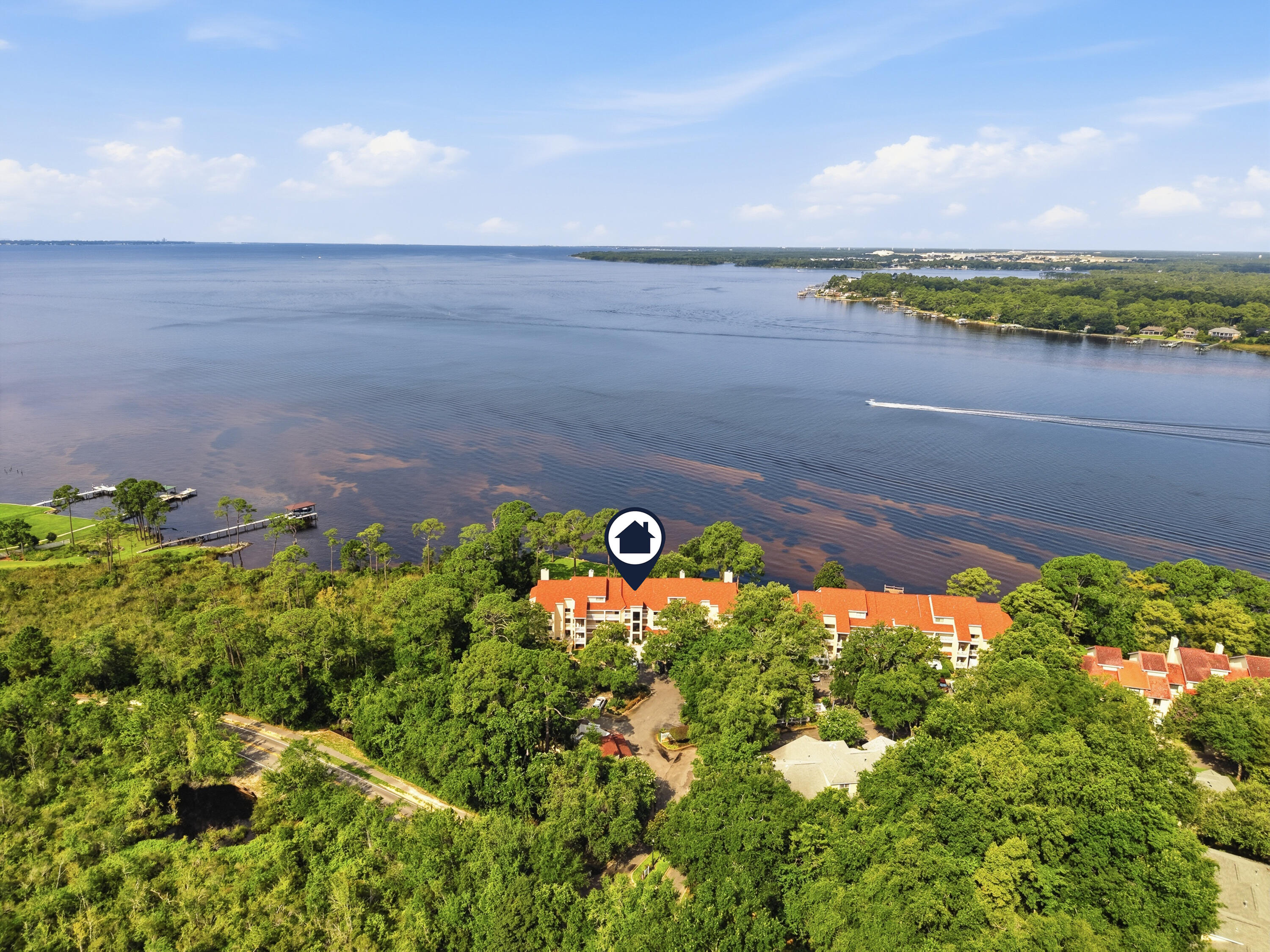 Experience waterfront living at its finest in this beautiful Bay Villas condo in the highly sought-after Bluewater Bay community! Offering breathtaking bay views and a peaceful coastal setting, this charming home is the perfect place to relax and unwind while enjoying everything the Emerald Coast has to offer.

Step inside to discover a spacious living area featuring luxury vinyl plank flooring, creating a warm and inviting atmosphere. Two large sliding glass doors flood the space with natural light and open directly onto your private waterfront patio--the perfect spot to enjoy your morning coffee, watch boats glide across the bay, or take in stunning sunsets!

The well-appointed kitchen is tucked away for added functionality and features a fully tiled backsplash, ample cabinet space, and convenient washer and dryer access just steps away. The updated bathroom offers a double vanity and walk-in shower, providing both style and comfort.

Ideally located just minutes from Eglin Air Force Base, top-rated schools, shopping, dining, and the beautiful white-sand beaches of the Emerald Coast, this exceptional waterfront condo offers the perfect blend of convenience and coastal charm. Don't miss your opportunity to enjoy bayfront living in Bluewater Bay. Contact us today to schedule a showing!
