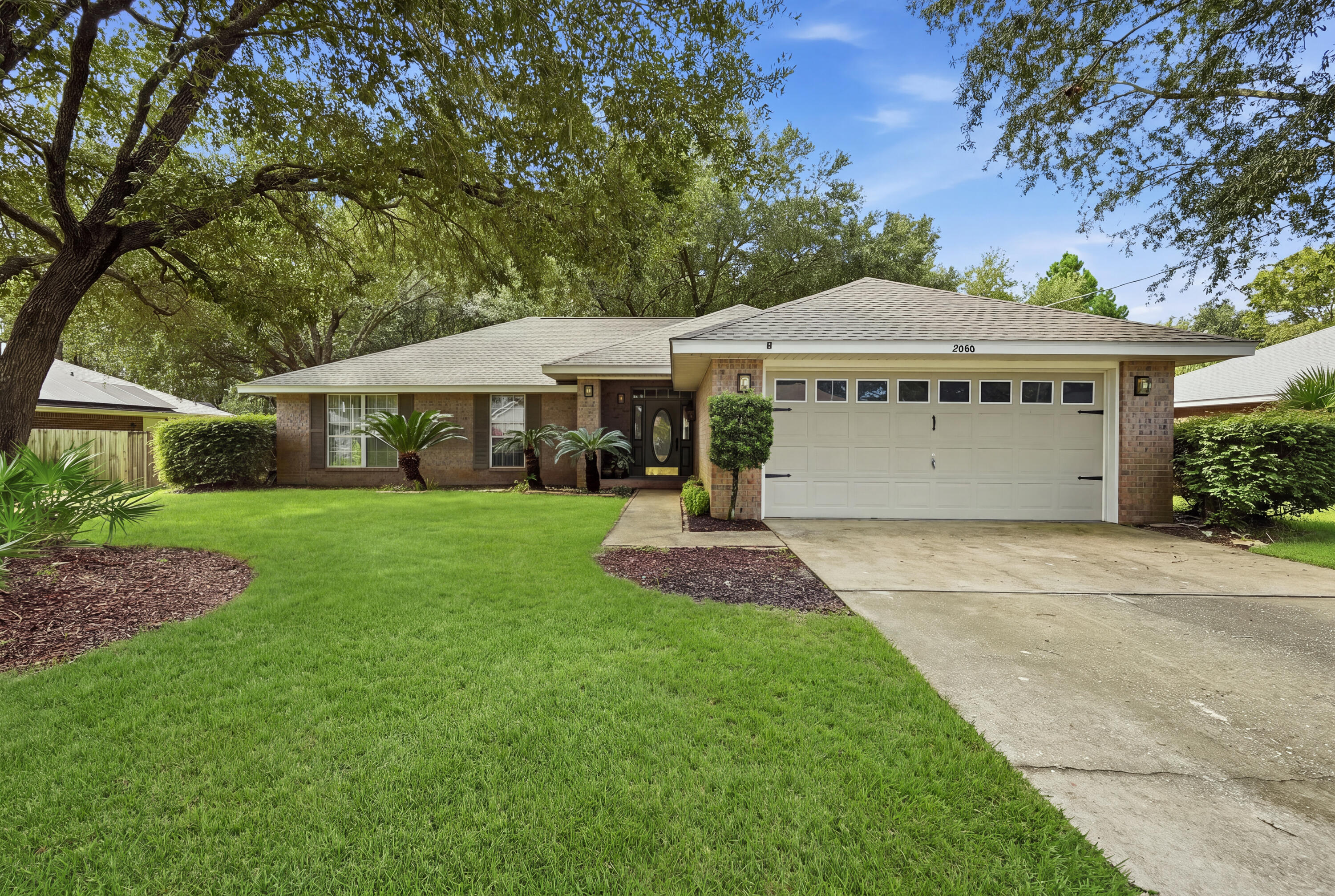 Welcome home to this newly painted beautifully maintained 4 sided brick residence offering approximately 1,800 square feet of comfortable living space, a private backyard, and a warm neutral palette that makes every room feel inviting. Nestled in a peaceful neighborhood, with NO HOA, this home offers the perfect combination of privacy, convenience, and relaxed Florida living. Park a boat, RV parking! Step inside to discover a spacious, easy-flowing floor plan accented by soft neutral shades   that provide a timeless backdrop for any decorating style. Tile flooring extends throughout the main living areas, kitchen, and one bedroom, offering both beauty and easy maintenance. The welcoming living area opens naturally to the kitchen and breakfast area, creating a comfortable gathering space for everyday living and entertaining. The kitchen features stainless steel appliances, new dishwasher, a beautiful neutral stone backsplash, ample workspace, and a dedicated area perfect for creating your own coffee or beverage bar. The adjoining breakfast area keeps everything open and connected while providing a cheerful spot for casual meals and morning coffee. With four bedrooms and two full baths, there is plenty of flexibility for family, guests, a home office, hobby room, or workout space. The home's neutral finishes allow you to move right in and easily make each space your own. Outside is where this property truly shines. Step onto the back patio and enjoy a private, fully fenced back yard surrounded by mature oak trees and overlooking a peaceful wooded area for privacy; Whether you're enjoying your morning coffee, grilling with friends, letting pets play, or simply unwinding at the end of the day, this backyard offers a wonderful sense of privacy and tranquility. Additional Features: well pump irrigation system for entire yard; Sentricon system/Termite bait station installed; Upgraded lighting and hardware; Conveniently located near primary schools, churches, restaurants, shopping, and the beautiful Gulf Coast beaches, this home puts everyday necessities and recreation within easy reach while still offering the peaceful neighborhood setting you've been searching for. Spacious, private, comfortable, and conveniently located--this 4-bedroom home is ready to welcome its next owner. Come experience the peaceful setting and inviting spaces that make this property feel like home from the moment you arrive!