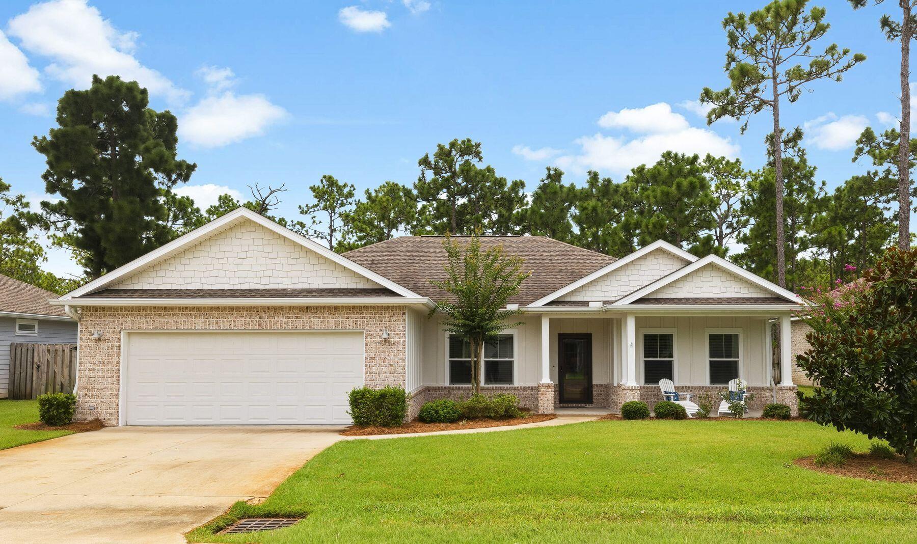 Beautifully maintained and thoughtfully appointed, this inviting Santa Rosa Beach residence offers the ideal balance of comfort, style and functionality. Located in a quiet 31-home neighborhood, the 2,045-sq.-ft. home features three bedrooms, two-and-a-half baths and a collection of custom finishes that elevate everyday living. The open-concept floor plan is filled with natural light and enhanced by coastal-inspired shiplap accents that add warmth and character throughout the living spaces. At the heart of the home, the bright kitchen showcases timeless white shaker-style cabinetry, stainless steel appliances and generous prep space for cooking and entertaining. A butler's pantry provides additional storage and organization, while the spacious laundry room is lined with abundant cabinetry to keep household essentials neatly tucked away. The primary suite offers a spacious and relaxing retreat with a large walk-in closet and well-appointed ensuite bath. Two guest bedrooms are connected by a Jack-and-Jill bathroom, creating an ideal arrangement for family or visitors, while a convenient powder bath serves the main living areas. Outdoor living is just as inviting. A screened porch provides the perfect place to enjoy morning coffee or unwind in the evening, while the expansive paver patio and fire pit create a natural gathering space for entertaining throughout the year. The generously sized backyard offers plenty of room to add a custom pool, allowing future owners to create their own private outdoor oasis. With low annual HOA dues of just $700, this intimate neighborhood offers a peaceful setting while remaining close to everything that makes Santa Rosa Beach so desirable. Residents enjoy convenient access to the sugar-white beaches and emerald waters of the gulf, Scenic Highway 30A, Grand Boulevard, Sacred Heart Hospital, local parks, shopping and an outstanding collection of restaurants and entertainment. Whether you're searching for a primary residence or a full-time coastal retreat, this exceptional location places the very best of the Emerald Coast just minutes from home.