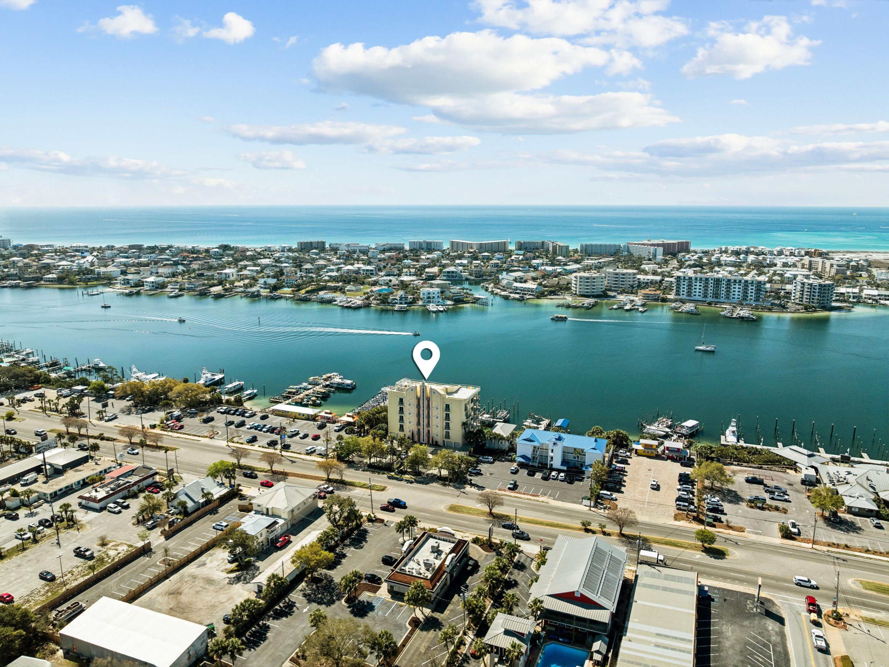 Welcome to Harbor Place 401 -- where sweeping panoramic views of Destin Harbor and the Gulf of Mexico meet the privacy of one of the harbor's most exclusive non-rental communities. Nestled within a boutique, low-density condominium community comprised of just 12 residences, this corner unit offers a rare opportunity to enjoy harbor-front living free from the constant turnover of short-term vacation rentals. Positioned to capture some of the community's most impressive vistas, the residence is wrapped in curved floor-to-ceiling windows that create an expansive viewing corridor, filling the home with natural light while showcasing breathtaking harbor activity, spectacular sunsets, and sparkling Gulf views beyond. Whether relaxing indoors or entertaining guests, the ever-changing waterfront scenery becomes part of everyday living. Inside, the approximately 1,315-square-foot residence offers two bedrooms and two bathrooms with a comfortable, thoughtfully designed layout equally suited for full-time living or a second home.

The kitchen is equipped with Samsung appliances, an LG electric range and cooktop, GE Adora dishwasher, and Whirlpool Gold icemaker. Additional features include powered blinds in the living areas and bedrooms, a lift TV in the primary suite, and a mechanical bed for added comfort and convenience.

Conveniently located along the harbor, Harbor Place is within walking distance of several of Destin's favorite waterfront dining destinations, including Marina Cafe, Boshamps, and Harbor Docks. 

Residents enjoy a swimming pool, fitness center, rooftop observation deck overlooking the harbor, dedicated owner storage, and a community dock with direct harbor access for paddleboarding, kayaking, and waterfront enjoyment. Additional community amenities include a gated building entrance, private parking with just 24 trellised parking spaces shared among only 12 residences, a paddleboard and kayak storage hut along the shoreline, and an approximately 8' x 10' secure storage space located on the building's basement level.

Harbor Place 401 is ideal for the buyer seeking the beauty and energy of Destin Harbor without the crowds of a vacation-rental community--a hidden waterfront retreat where low-density living, exceptional views, and a true sense of ownership come together.