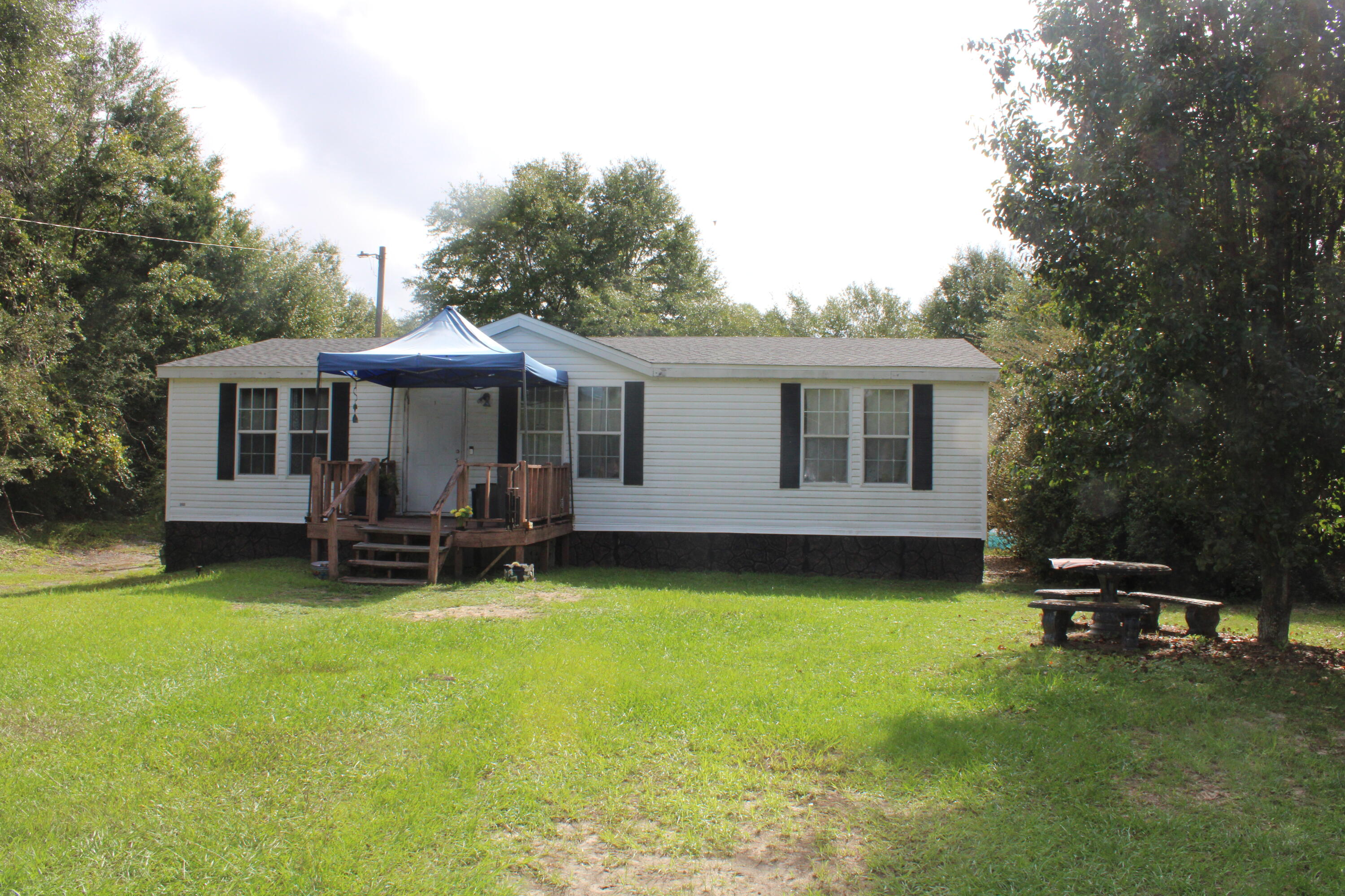 COUNTRY LIVING WITH ROOM TO BREATHE!

This 3-bedroom, 2-bathroom manufactured home offers approximately 1,188 square feet of living space and sits on a spacious 1-acre parcel, providing plenty of room for outdoor living, pets, gardening, hobbies, or simply enjoying the peace and privacy of a larger lot.

Built in 2003, the home features a practical one-story floor plan with comfortable living spaces, a central kitchen, and a primary suite with its own bathroom. 

Conveniently located in the DeFuniak Springs area, this property offers the best of both worlds: a peaceful country setting while remaining within reasonable driving distance of town, shopping, dining, schools, and area amenities.

Whether you're looking for an affordable primary residence, a property with room to grow, or an investment opportunity, this 1-acre property is worth a look!

Highlights:
• 3 bedrooms
• 2 bathrooms
• Approximately 1,188 sq. ft.
• Approximately 1 acre
• Built in 2003
• One-story layout
• Central HVAC
• Spacious lot with room for outdoor activities
• Quiet DeFuniak Springs location

Schedule your private showing today and discover the possibilities.