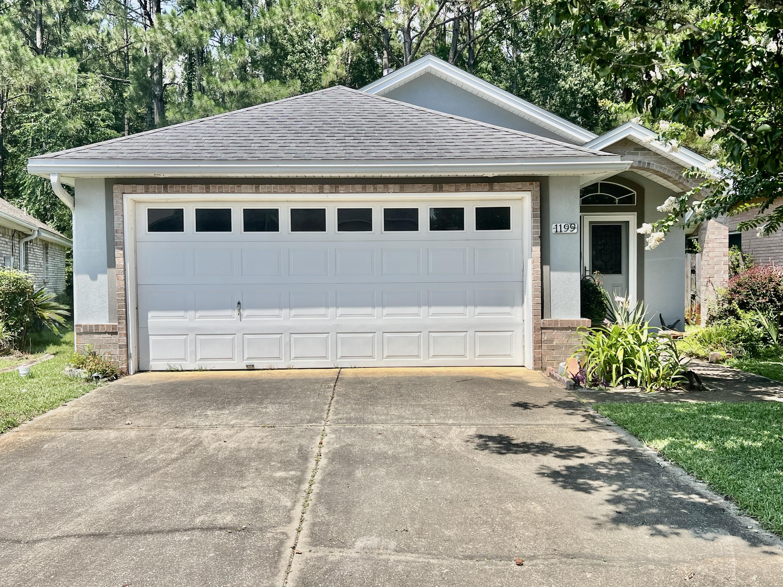 Welcome home to this beautifully maintained, move-in ready home in the desirable Northridge Creek community!  A charming covered front porch, accented by a beautiful crape myrtle, creates a warm first impression.  Inside, you'll love the open concept layout with tray ceilings, a spacious family room with a gas fireplace, and a kitchen featuring stainless steel appliance and a breakfast bar - perfect for entertaining.  Tile and wood flooring flow throughout the main living areas.  The split bedroom floor plan offers privacy for guests, while the generous primary suite includes private access to the screened porch and an ensuite bath with a walk in shower with built in seating as well as the walk in closet.  Relax on the screened porch overlooking a private, fenced backyard with mature trees.  Roof replaced in 2014, HVAC 2015.  Hurricane Shutters. Two car garage, spacious laundry room, low annual HOA, plus a community gazebo and boardwalk just a short stroll away.  This community has 117 single family homes.  All information and dimensions are to be verified by the buyer prior to closing.