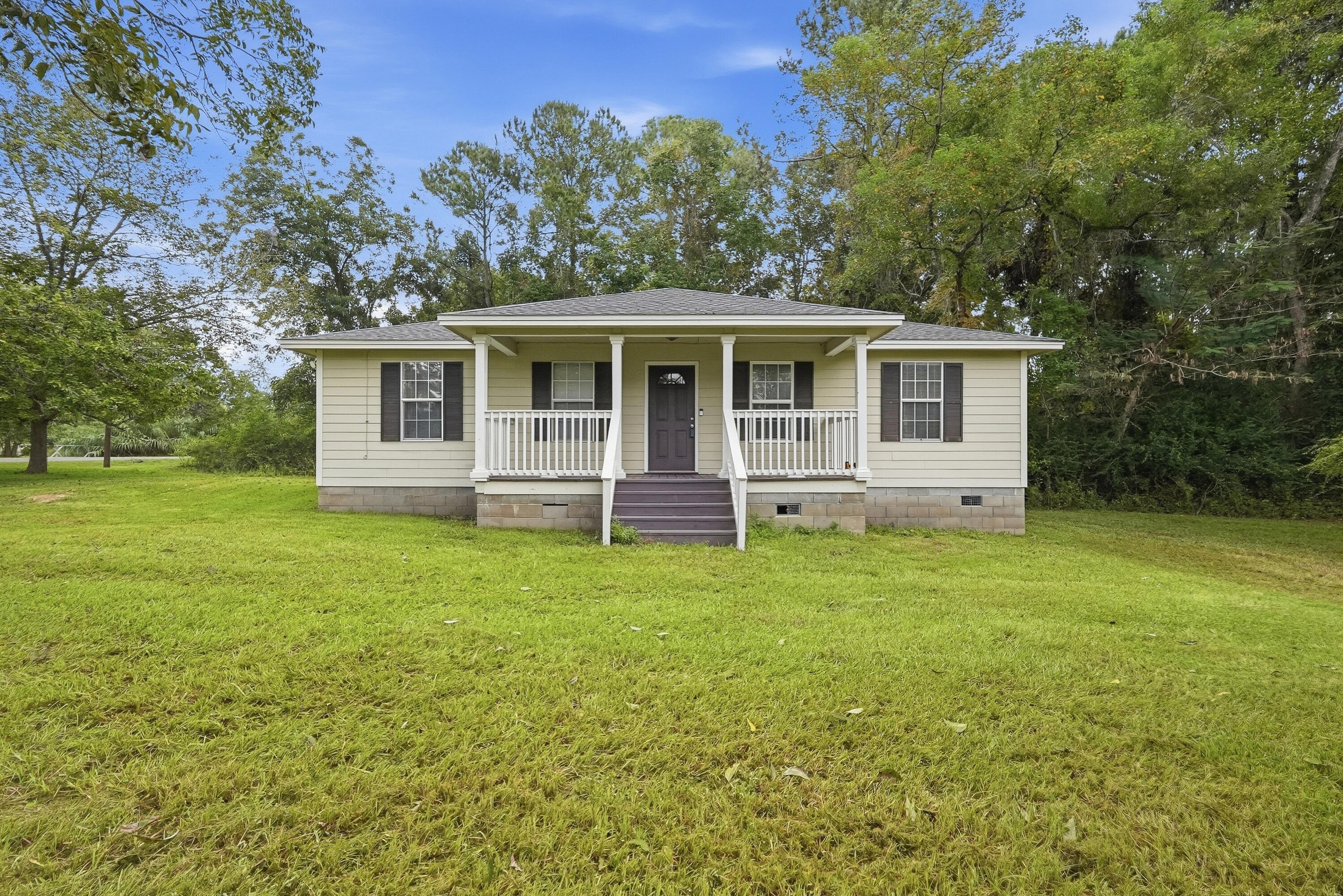 Located just a block from Laurel Hill School, this 3BR 2BA home is adorable and affordable! Sitting on over 1.15 acres the home welcomes you with a large, covered porch, a large yard with trees still giving you privacy and tons of room for outdoor activities. The home has a large open living room, connecting dining room as well as a kitchen with plenty of cabinet space and counter space. The primary bedroom offers a great bath, and the second bath has great updates for the 2 additional bedrooms. Home is move in ready! Great location with a great price on a great home! Home currently just had a brand-new roof placed on home as well!