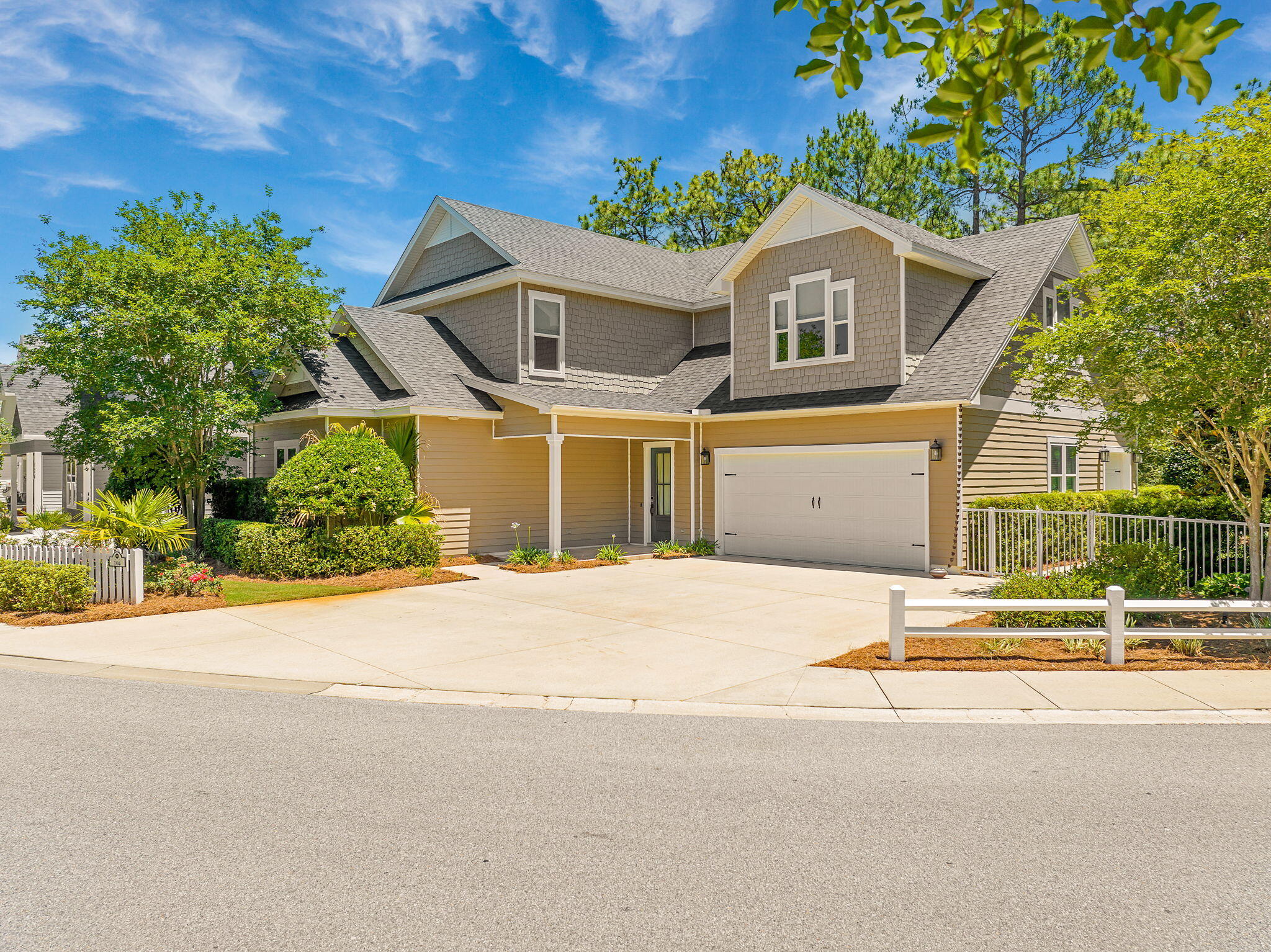 One of the largest and most extensively upgraded homes in Paradise Cove, this exceptional Boswell Builders residence is positioned on a generously sized homesite with peaceful wooded views, thoughtfully designed indoor-outdoor living spaces, and a level of craftsmanship that sets it apart within the community, all just minutes from 30A and the Emerald Coast's renowned beaches, dining, and shopping.

Designed with both everyday comfort and entertaining in mind, the home showcases an open-concept floor plan with 10-foot ceilings, crown molding, custom millwork, wainscoting, and expansive living spaces filled with natural light. The main living area is anchored by a striking fireplace wall with custom built-ins and opens seamlessly into a beautifully appointed chef's kitchen featuring stacked custom cabinetry, an oversized island, mirrored backsplash, premium stainless appliances, and designer lighting.

The primary suite offers a true retreat with a dramatic coffered ceiling, oversized custom walk-in closet, and a spa-inspired bath complete with white Carrera marble countertops, a freestanding soaking tub, and an expansive frameless glass shower with luxury finishes throughout. Spacious guest bedrooms feature oversized closets, while the large upstairs bonus room with wet bar and private bath offers incredible flexibility as a media room, recreation space, guest suite, or additional bedroom.

Outdoor living was intentionally designed to be a centerpiece of the home. Enjoy peaceful wooded views from the screened porch or gather beneath the pergola around the custom oversized 5x6 fire pit, an inviting outdoor space designed for relaxing and entertaining. Front and rear porches are both reinforced and designed to accommodate porch swings, further enhancing the relaxed coastal lifestyle feel. Professionally curated landscaping, custom lighting, artificial turf, and mature greenery create a private, low-maintenance outdoor setting that feels both refined and welcoming.

Additional upgrades include whole-house foam insulation, impact-rated tinted windows filled with argon gas for enhanced energy efficiency, durable 2x6 construction, Hardie Board ColorPlus siding, whole-house surround sound, WiFi-controlled irrigation, WiFi-enabled whole-house generator, dual 120-gallon propane tanks, and smart-home wiring throughout.

Paradise Cove is one of the area's most sought-after non-short-term-rental communities, known for its white picket charm, peaceful atmosphere, and proximity to 30A, Seacrest Beach, Eden Gardens State Park, Choctawhatchee Bay, and the best of coastal living along Scenic Highway 30A.