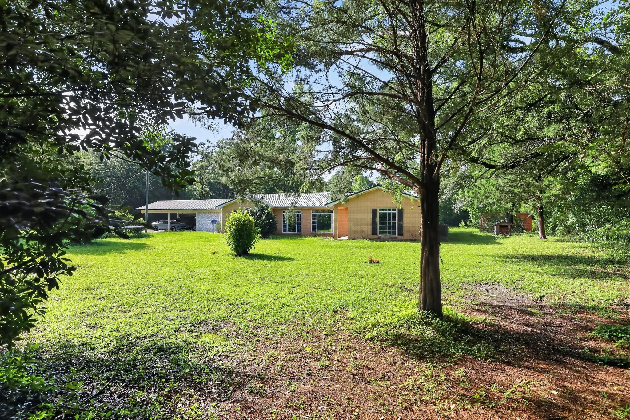 ****Highest and best due by 8/20/2026 @ 5pm ****Enjoy peaceful country living in this beautiful 4-bedroom, 2.5-bath ranch home situated on approximately 8.69 acres just south of Bonifay. The spacious home features a welcoming great room with a fireplace, two inviting sunrooms, and a large primary suite offering two huge walk-in closets and an exit door leading directly to one of the sunrooms.  Additional features include double-pane windows and insulated exterior doors for added comfort and energy efficiency. Outside, the property provides plenty of space to enjoy the peaceful country setting, along with a workshop, two wells, and pond. Enjoy the privacy and space of acreage while still being within a short drive of Ponce de Leon Springs and the beautiful Panama City beaches. This property offers a wonderful opportunity to enjoy a relaxed country lifestyle with room to spread out, garden, entertain, or simply enjoy the peaceful surroundings. 32'x60' garage / workshop w/ rollup door on front, pedestrian door, and the electric bill is separate from home 240V and 120V outlets