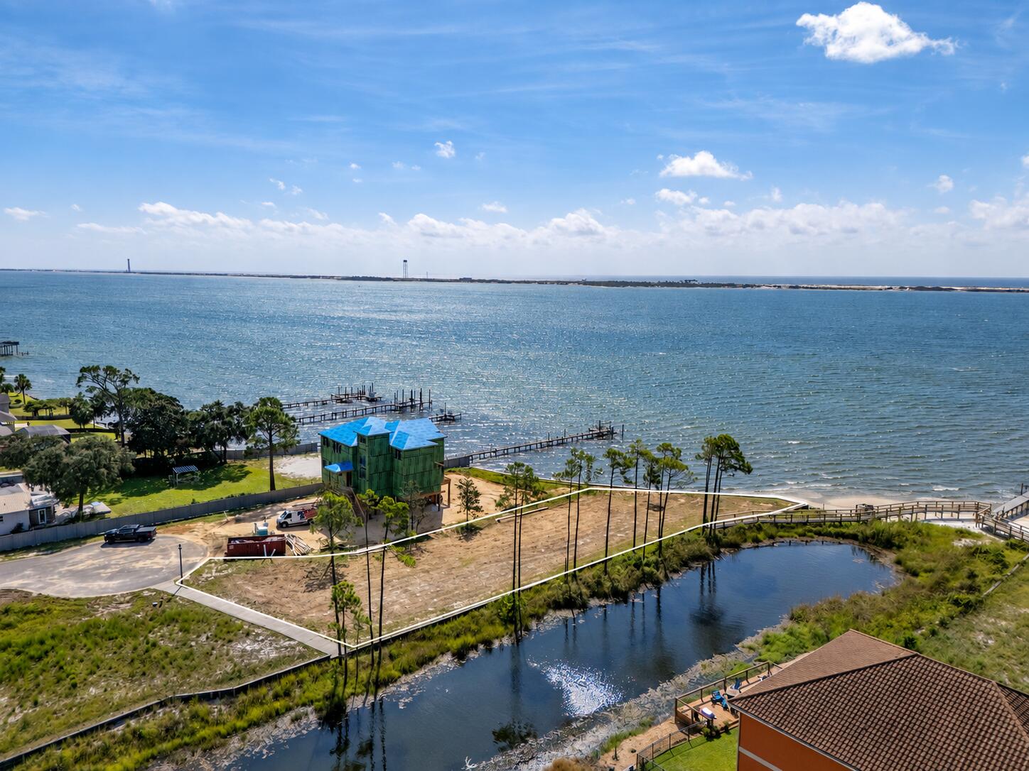 WATERFRONT HOMESITE WITH BOAT SLIP! Build your dream home in Palmetto Lake Preserve, an intimate gated community approximately two miles east of the Navarre Beach Bridge. This level 0.45-acre lot offers approximately 126 feet of water frontage, with Santa Rosa Sound to the south and Palmetto Lake to the west -- creating expansive water views on two sides and only one direct neighboring property.

Boat Slip #9 conveys with the property and provides deep-water access from the community dock. Additional features include a newly constructed retaining wall along the western edge, a seawall boardwalk with low-maintenance synthetic decking, riprap, and access to public water and sewer. The community is known for its beautiful custom Mediterranean-style homes and peaceful waterfront setting.

Imagine enjoying colorful sunsets, refreshing coastal breezes, and views of Navarre Beach Island from your future home. Travel by boat or drive about 2.5 miles to Navarre Beach for sugar-white sand and emerald-green waters. Bring your builder and begin planning your own waterfront retreat along Florida's beautiful Emerald Coast!