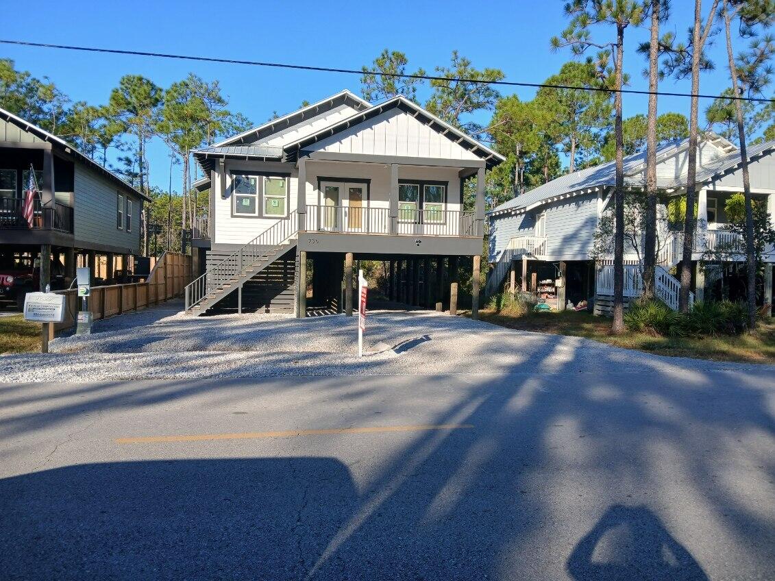 PRICE IMPROVEMENT! Ideally located just minutes from the beach and bayou with convenient access to a nearby boat launch, this beautifully appointed home offers comfort, style, and versatility. The open-concept great room flows seamlessly into a spacious country kitchen featuring quartz countertops, custom cabinetry, recessed lighting, a large pantry with built-in shelving, stainless steel Frigidaire appliances, a center island with breakfast bar, and an adjacent dining area.
The private primary suite is filled with natural light and includes a generous walk-in closet with custom built-in shelving, a well-designed bath with designer tile and fixtures, and a charming barn door accent. Step out onto the primary balcony and enjoy your morning coffee in the fresh coastal air. Two additional bedrooms offer ample closet space and flexibility for family or guests. Additional highlights include easy-maintenance LVL flooring throughout, a separate laundry room with its own exterior entrance, and washer and dryer included. Ideal as a primary residence, vacation home, or potential Airbnb investment. One-year builder warranty included.