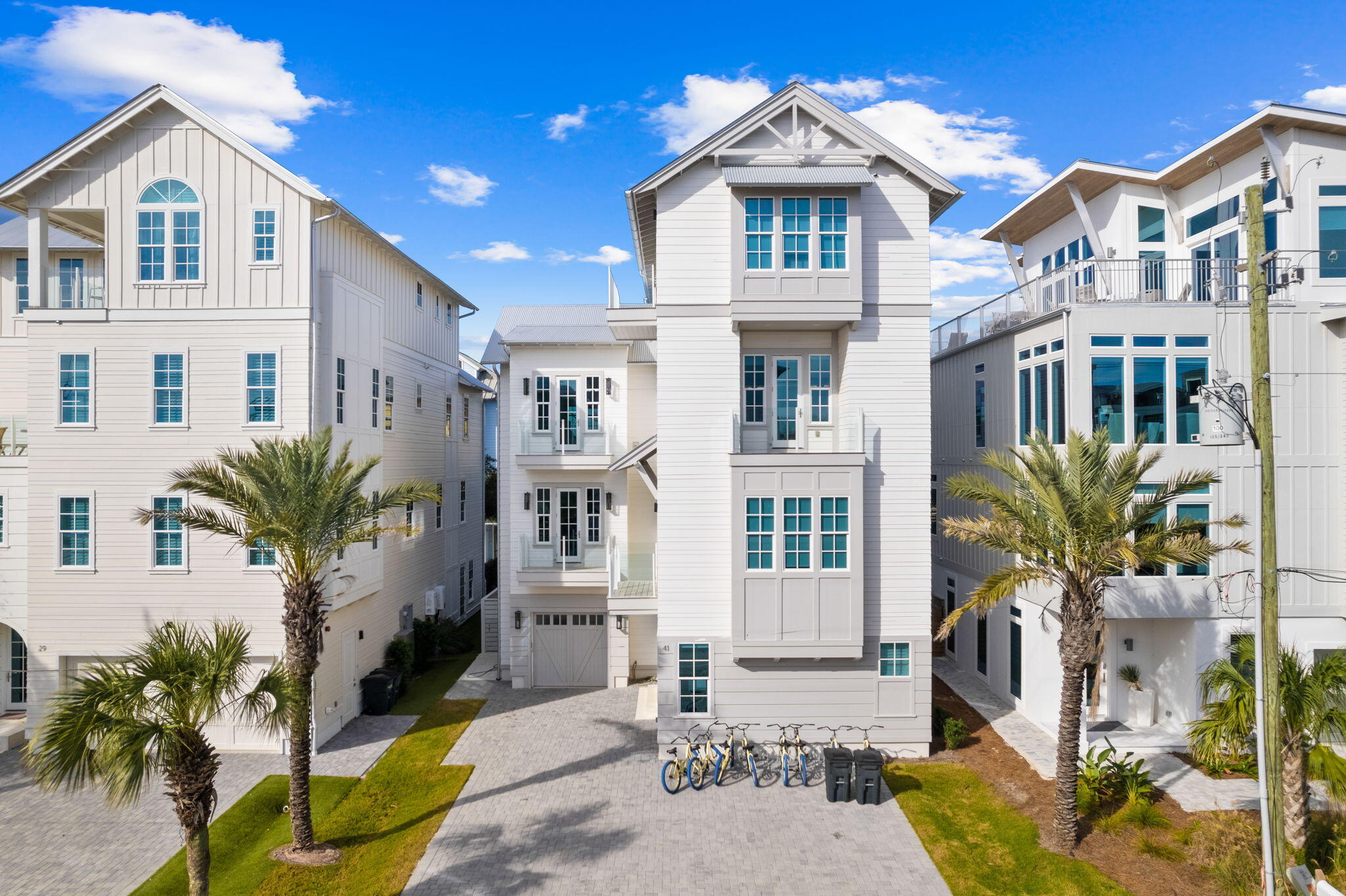 Properties of this scale and modern design are incredibly rare this close to both the beach and Seaside, offering a unique opportunity to own a spacious, luxury home without sacrificing walkability or location. Thoughtfully designed for both elevated coastal living and strong rental potential, this home stands out as a true gem in one of 30A's most sought-after areas. Built in 2021, this exceptional residence seamlessly blends modern luxury with timeless coastal charm, making it an ideal primary home, vacation getaway, or high-performing rental investment. Thoughtfully designed with authentic character, the home features 200-year-old reclaimed wood beams, shiplap walls, and hardwood floors throughout, creating a warm yet refined aesthetic. Custom iron railings and tempered glass balcony railings add a sophisticated, contemporary touch, while Italian marble--Calcutta Gold and White Carrera-elevates every bathroom into a spa-like experience.

The chef's kitchen is outfitted with designer cabinetry and premium finishes, perfect for entertaining large groups.

With eight bedrooms and expansive living spaces across four levels, this home is perfectly suited for large family gatherings or maximizing rental potential. The third-floor primary suite is a true sanctuary, complete with a luxurious en-suite bath featuring a freestanding soaking tub, double vanities, and a spacious walk-in shower. A dedicated bunk room with its own bath and additional common area provides the perfect setup for guests or kids.

The fourth floor offers a media room and opens to a large rooftop deck with a wet bar and beverage fridge--ideal for entertaining while taking in breathtaking Gulf views. Outside, enjoy your private oasis with a large pool, uniquely designed with both covered and open areas for year-round enjoyment.

Offering the best of location, design, and income potential, this property presents an incredible opportunity.