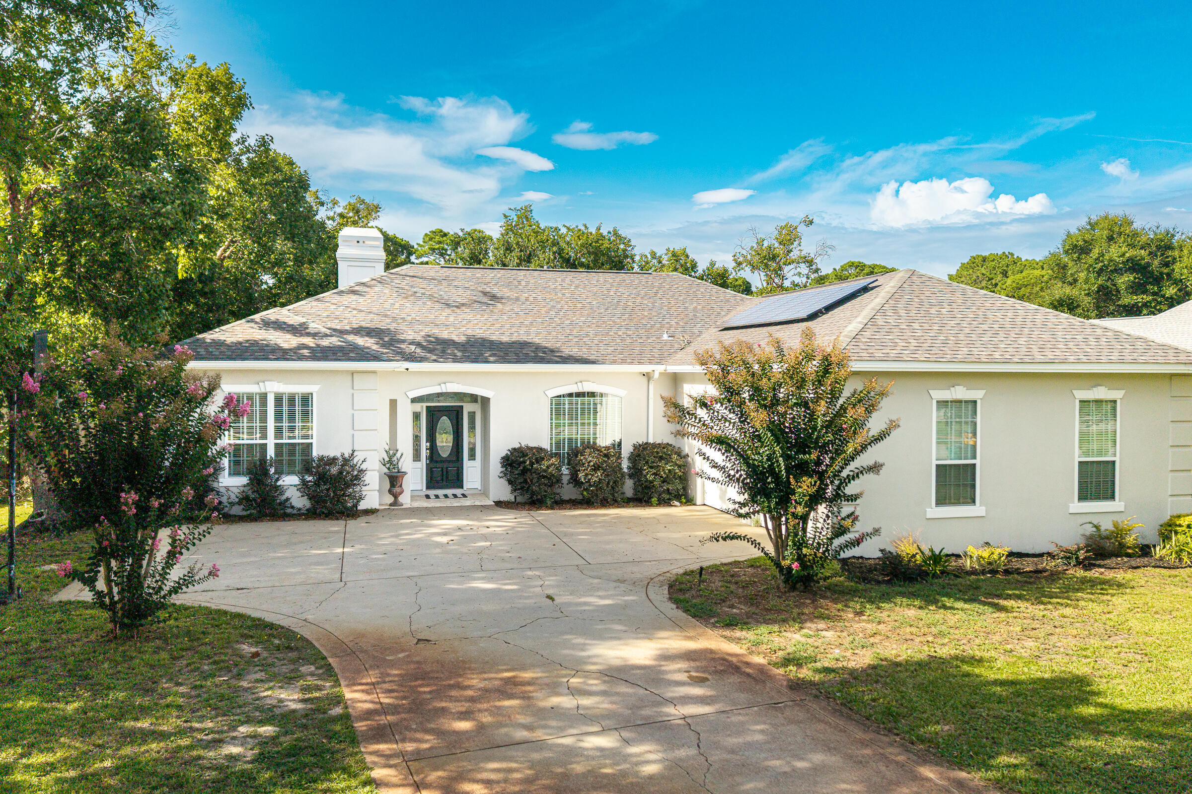 BEAUTIFULLY UPDATED ONE-LEVEL HOME ON A QUIET CUL-DE-SAC IN WINDSOR FORREST -- INDIAN TRAIL COMMUNITY

RECENT UPDATES & FEATURES:

• Paid-off solar panels installed in 2019 -- owners average approximately $37/month for electricity
• Premium French white oak hardwood flooring -- September 2025
• New smart refrigerator -- 2025
• WiFi-enabled dual garage door openers -- 2025
• HVAC + Nest thermostat -- 2019
• Water heater -- January 2019
• WiFi-enabled oven -- June 2021
• Gas stove
• Microwave -- August 2023
• Dishwasher -- Fall 2023
• Built-in desk with shelving
• Several WiFi-enabled light switches
• WiFi-enabled sprinkler system
• WiFi-enabled lighting in the primary bedroom and bathroom
• WiFi-enabled exterior front lights
• Spacious backyard with room and potential for a future pool
• Quiet cul-de-sac street with minimal through traffic
• Home is set back from the street with sidewalks and a generous driveway

Beautifully maintained and thoughtfully updated, this one-level home is ideally situated on a quiet cul-de-sac street in the desirable Windsor Forrest subdivision within the highly sought-after Indian Trail community of Destin. Set back from the quiet street, the home enjoys a peaceful front setting with sidewalks and a generous driveway providing plenty of parking for residents and guests. Offering a spacious split-bedroom floor plan, this home combines comfort, style, functionality, and modern updates in a location that puts you just minutes from everything  has to offer.

Step inside and you'll immediately notice the premium French white oak hardwood flooring installed in September 2025, bringing a fresh, sophisticated look and timeless appeal throughout the home. The inviting floor plan provides an easy flow between the spacious living room, dining area, and kitchen, creating an ideal setting for both everyday living and entertaining.

The oversized primary suite offers a private retreat with a generously sized ensuite bathroom featuring his-and-her closets, a large vanity with dual sinks and adjustable lighting, a separate shower and tub, and a private enclosed water closet, along with plenty of space to relax and unwind. Additional bedrooms provide flexibility for family, guests, a home office, or whatever best fits your lifestyle. A convenient half bath is also perfectly positioned for guests.

The spacious kitchen serves as the heart of the home, featuring a large breakfast bar with ample seating, a gas stove, and an easy connection to the living and dining areas. Recent appliance updates include a WiFi-enabled oven installed in June 2021, microwave, dishwasher, and new smart refrigerator, bringing modern convenience to this well-appointed space. A built-in desk with shelving provides a convenient workspace for household organization, homework, or working from home.

One of the home's standout features is the paid-off solar panel system installed in 2019. The owners currently average approximately $37/month for electricity, offering an energy-efficient feature that can provide meaningful savings on ongoing utility costs.

The outdoor living space is equally inviting. Enjoy your morning coffee or evening gatherings on the screened-in porch overlooking the expansive backyard. The generous yard provides plenty of room to create your own private oasis, with space and potential for a future pool.

Smart-home conveniences throughout the home include WiFi-enabled dual garage door openers, several WiFi-enabled light switches, a WiFi-enabled sprinkler system, WiFi-enabled lighting in the primary bedroom and bathroom, and WiFi-enabled exterior front lights. The Nest thermostat adds additional convenience and control to the home's HVAC system.

Located in the established and sought-after Indian Trail community, this home is just minutes from Destin's renowned white-sand beaches, boating, shopping, dining, entertainment, and schools.

Premium new flooring, paid-off solar, a gas stove, updated appliances, a built-in desk with shelving, newer HVAC, extensive smart-home features, a spacious primary suite, a screened-in porch, and a generous backyard with pool potential -- all on a quiet cul-de-sac in the desirable Windsor Forrest subdivision within Indian Trail. This is a home you'll want to see in person.