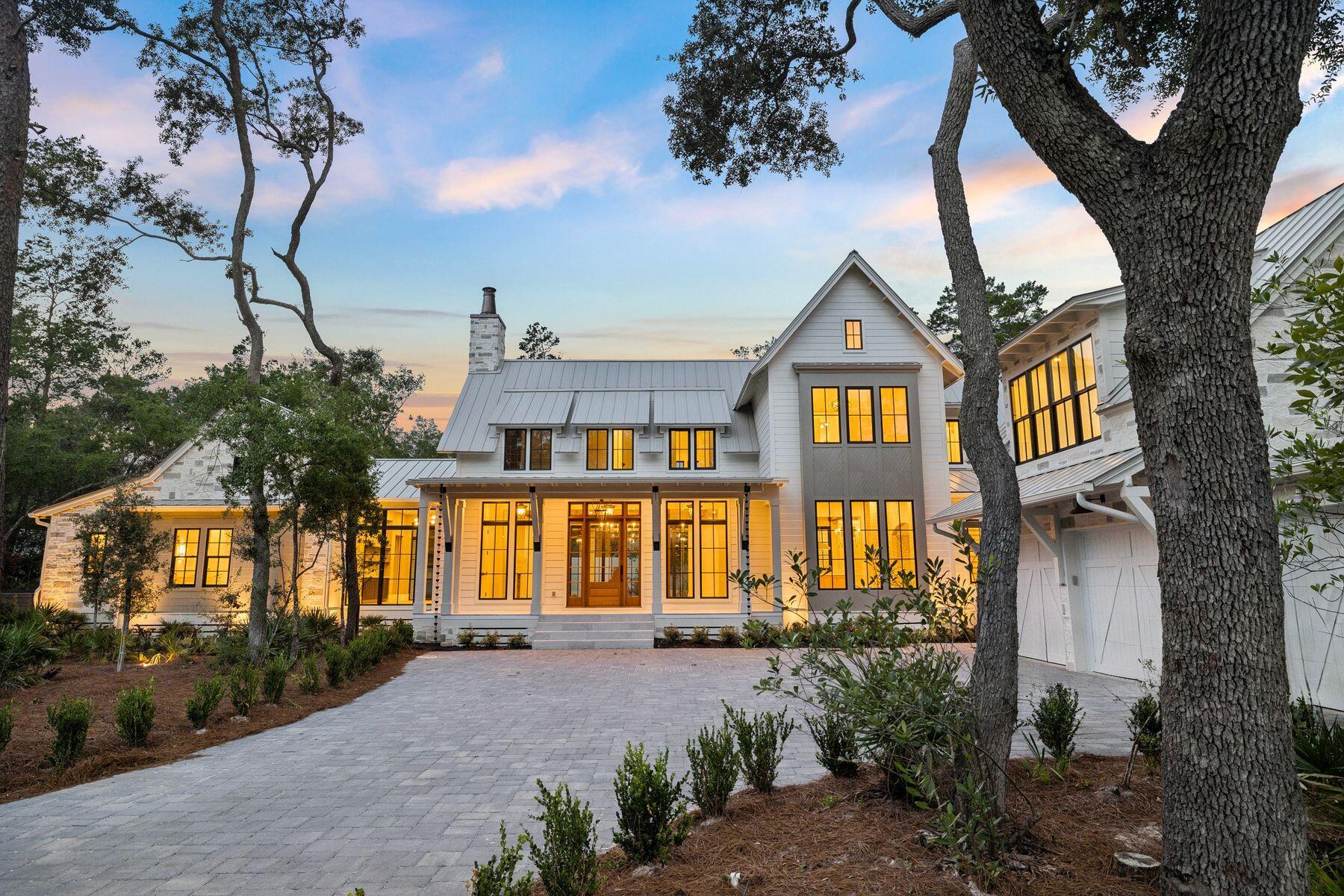 Nestled on a half-acre lot among century-old oaks and pines in historic Point Washington, this newly constructed residence sets a new standard for coastal luxury. The builder's reputation for curating fine materials -- sourced from France, Spain, Morocco, Belgium, Turkey, and England -- is on full display. At 5,390 square feet across two floors, with five bedrooms, five and a half bathrooms, a gym, and a spa, the home is designed so all principal living happens on one floor. Over 1,374 square feet of outdoor space connects the interior to a backyard made for quiet mornings and effortless entertaining. The exterior is clad in Texas-quarried Peppered Limestone and lit by handmade Bevolo lanterns. Inside, the foyer's Venetian Grey and White Tumbled Marble sits beneath E.F. Chapman lanterns. Eight-inch French hardwood floors run throughout, topped by reclaimed French Oak beams finished in natural oil. Custom plaster walls appear throughout, with limewashed surfaces in the office and primary bedroom adding warmth paint can't replicate. The back yard offers a resort-style pool and hot tub set within Flemish Grey Limestone decking, a covered living area with fireplace and wood ceiling, and an outdoor kitchen with a six-burner Coyote grill, refrigerator, and leathered countertops. An outdoor shower, astroturf lawn off the primary bedroom, and a scalloped privacy wall complete the space beneath a natural oak and pine canopy near the bay.  The main floor's open kitchen, living, and dining areas flow beneath reclaimed beams, with a Nana door opening fully to the backyard. The kitchen features a full Thermador suite, an English Shaw's sink, a Sub-Zero wine fridge, custom oak cabinetry with brass hardware, and a quartz island under Suzanne Kasler pendants. A hidden scullery with a plumbed Miele coffee maker keeps the kitchen composed. The primary bedroom offers limewashed plaster walls, a hand-painted pecky cypress herringbone wall, a reclaimed French Pine beam, Spanish Alabaster sconces, a fireplace, and direct porch and pool access. Its bathroom includes heated marble floors, dual vanities, Brizo fixtures, and a gold-fixtured rain shower, plus a closet with a built-in makeup vanity. A first-floor guest suite features Moroccan Zellige tile and private exterior access. A limewashed office, mudroom, laundry room with dog bath, and powder room with a Turkish sink complete the level, alongside built-in speakers, designer lighting, and brass hardware throughout. Upstairs holds a bedroom with reclaimed beams, a blue-themed bedroom, a flexible study or children's room, and sitting areas. Two bathrooms serve the floor, one a showpiece of blue-and-white penny tile. A large closet with shoe storage and a covered porch finish the level. The wellness suite features Belgian Bluestone floors, a cold plunge tub, a two-person infrared sauna, and a Moroccan plaster steam shower with island stone floors. Above the three-car garage, a self-contained carriage house with oak floors, paneling, a full kitchen, and a penny-tile bath offers independent living for guests or family.Outside, the rear of the home is designed for serious outdoor living. A resort-style pool and hot tub are set within Flemish Grey Limestone decking, and a covered living area features a fireplace, wood ceiling, and Bevolo lanterns. The fully equipped outdoor kitchen includes a six-burner Coyote grill, refrigerator, and leathered countertop. An outdoor shower, astroturf lawn accessible from the primary bedroom, and a scalloped privacy wall complete the picture. The bay is just moments away, and the surrounding oak and pine canopy provides a natural privacy that no fence could replicate.
The main living area occupies the entire first floor, with the kitchen, living, and dining rooms flowing together in an open, unhurried plan. The living room is anchored by beautiful reclaimed beams overhead, and a Nana door opens fully to the backyard, connecting the interior effortlessly to the outdoor entertaining space beyond. The kitchen is anchored by a full Thermador appliance suite, a Shaw's sink imported from England, and a Sub-Zero wine refrigerator. Custom oak cabinetry with brass hardware runs throughout, and the island -- topped in quartz and hung with Suzanne Kasler concrete pendants -- is sized generously for seating and gathering. Behind a discreet door, a fully equipped scullery with a plumbed Miele coffee maker keeps the main kitchen clear and composed.
The primary bedroom is a considered retreat -- limewashed plaster walls, a hand-painted pecky cypress herringbone feature wall, a center beam of reclaimed imported French Pine, and Spanish Alabaster stone sconces. A fireplace anchors one wall, and direct access to the porch and pool area is just steps away. The primary bathroom offers heated marble floors, his and hers vanities, Brizo fixtures throughout, and a large shower with gold fixtures and an oversized rain head. The primary closet is generously sized with enclosed shelving and a built-in makeup vanity.
A first floor guest bedroom with en-suite bath finished in imported Zellige Moroccan tile offers its own private exterior access. A dedicated office with limewashed walls provides a calm and considered workspace. Practical spaces -- a mudroom, laundry room with dog bath, and powder room with an imported Turkish sink -- are finished with the same care given to the principal rooms.
Built-in speakers, designer lighting, and brass hardware throughout speak to a home where the details were never an afterthought.
Upstairs, the home offers a large bedroom with reclaimed wood beams, a charming blue bedroom, a flex room suited to a study or children's space, and generous sitting areas. Two well-appointed bathrooms serve the level, one of which is a showpiece of blue and white penny tile with a matching vanity and shower. A large closet with dedicated shoe storage and a sweeping covered outdoor porch complete the upper floor.
The wellness suite is in a category of its own. Belgian Bluestone floors, a custom cold plunge tub, a two-person infrared red light sauna with Bluetooth, and a Moroccan plaster steam shower with island stone floors together create a space devoted entirely to restoration. Few homes at any price point offer this combination under one roof.
Above the oversized three-car garage, a self-contained carriage house with oak floors, oak wall paneling, a full kitchen, and a penny tile bath offers complete independence for extended family or long-term guests -- a fitting complement to a home of this caliber.