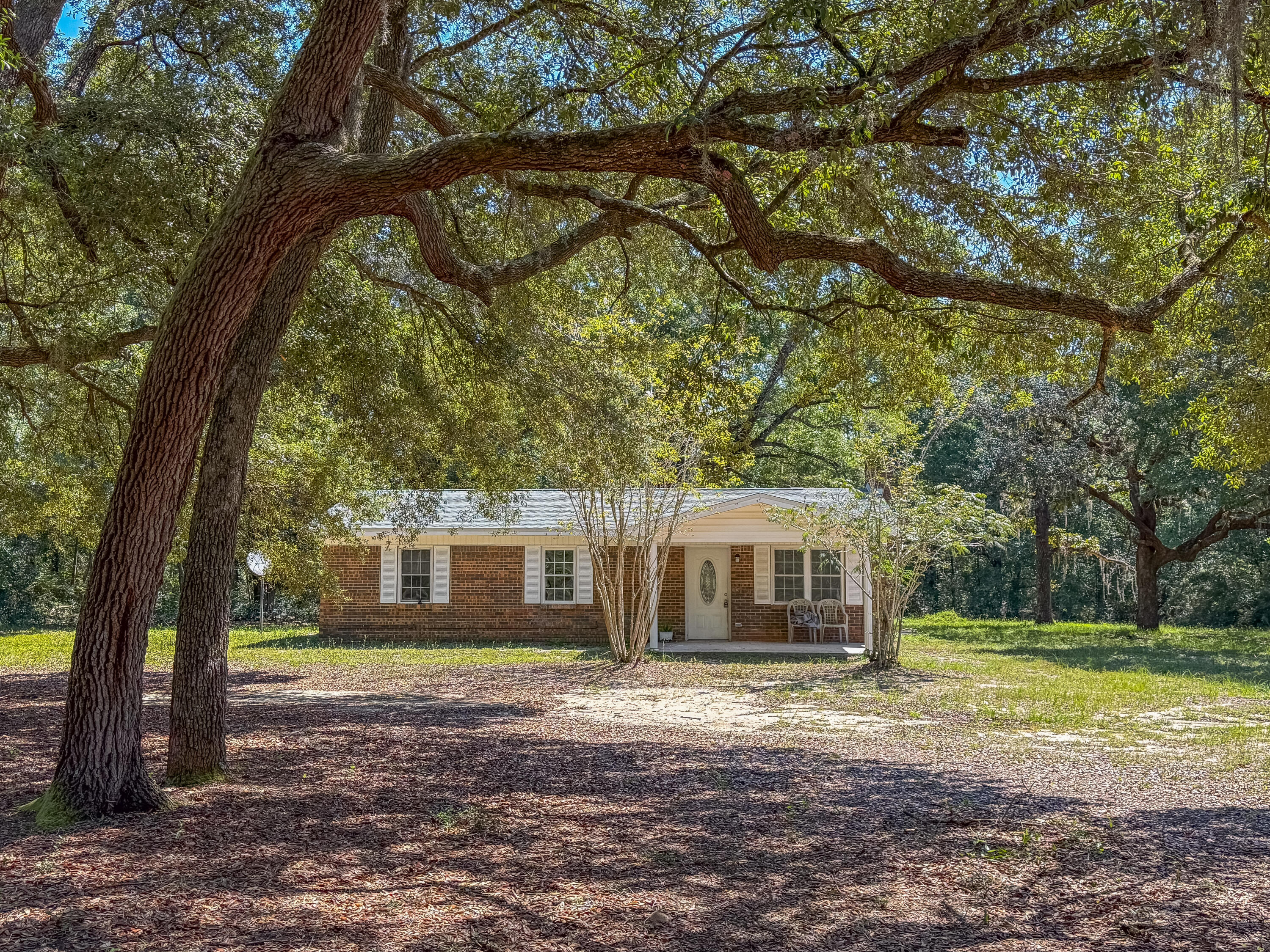 This 4BR/2BA home will sit on approximately 2 acres and has had all the major updates completed, including a newer roof, HVAC, flooring, electrical, and septic. The roof was replaced in March and the HVAC and electrical wiring in July! The home features a split floor plan, fireplace and a versatile bonus room that can be used as an office, dining area, or flex space. Mature oak trees and azaleas adorn the property giving it that country Florida vibe. There's plenty of room for your horses, chickens, or garden! Located on Old River Road, the property offers the peace and quiet of country living while remaining convenient to Crestview. The landscaping is a blank canvas, and ready for your personal touch. Contact me today to schedule a private showing!