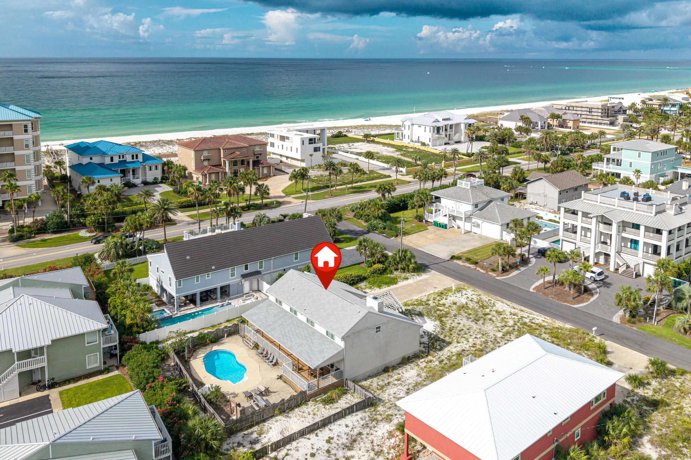 Offered for the first time by its original owners, this cherished Holiday Isle beach house has been a beloved family retreat since 1983. Situated directly across from the sugar-white sands and emerald waters of the Gulf, the property presents a rare opportunity to own in one of Destin's most sought-after beachside neighborhoods.

Spanning nearly 3,500 square feet, the home offers 5 bedrooms and 3 baths, including a first-floor guest suite with ensuite bath and four additional bedrooms upstairs. Warm wood-paneled walls, a striking two-way stone fireplace, and inviting gathering spaces create a cozy, nostalgic atmosphere reminiscent of a mountain lodge by the sea.

Outdoor living is equally appealing with a newly added covered deck (2025) overlooking the private in-ground pool, providing the perfect setting for entertaining and relaxing after a day at the beach. Additional updates include a roof replacement in 2020. The enclosed garage currently serves as a game room and hangout space but could easily be converted back to a traditional garage.

Whether you're dreaming of restoring its original charm, creating a custom coastal retreat, or building new in an exceptional location, this property offers endless possibilities. Homes on Holiday Isle with this combination of size, location, and beach access are increasingly rare. Bring your vision and make this iconic family beach house the foundation for its next chapter.