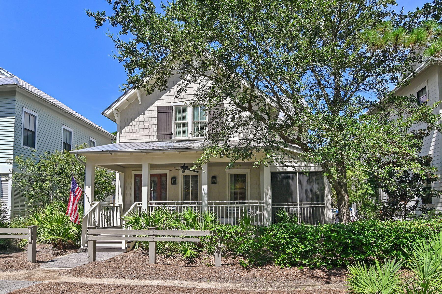 This beautifully designed four-bedroom, four-and-a-half bath coastal retreat is perfectly situated just steps from Camp WaterColor, offering an exceptional blend of style, comfort, and location. From the shingled exterior and gracious front porch to the tranquil blue and white interiors, every detail is thoughtfully curated for relaxed yet refined beach living. An inviting natural wood front door opens to an airy, open-concept layout where casually elegant living and dining spaces flow seamlessly. The chef's kitchen is a highlight, featuring professional-grade stainless steel appliances, gleaming quartz countertops, a spacious island, and warm, wrought-iron pendant lighting. Designer finishes, transitional furnishings, and coastal accents set an atmosphere of understated sophistication. Ideal for family gatherings, the home offers generous seating indoors and out, including a large screened side porch perfect for alfresco dining. Two master suites  one on each floor  provide privacy and flexibility, with the upstairs suite featuring a sitting area and window seats. All baths are modern and beautifully appointed, featuring luxurious details such as a large soaking tub and a walk-in shower in the primary suite. Exceptional craftsmanship is evident throughout, from crown molding and coffered ceilings to hardwood floors, wainscoting, and custom window treatments. A fully equipped laundry room, Navien tankless water heater, multiple smart televisions and low-maintenance landscaping add convenience, while paver parking and an architecturally matched storage shed enhance the property's practicality. With access to WaterColor's unrivaled amenities  swimming pools, tennis and pickleball courts, beachside dining and more  this elegant home is the perfect sanctuary for families and friends seeking the quintessential coastal lifestyle.