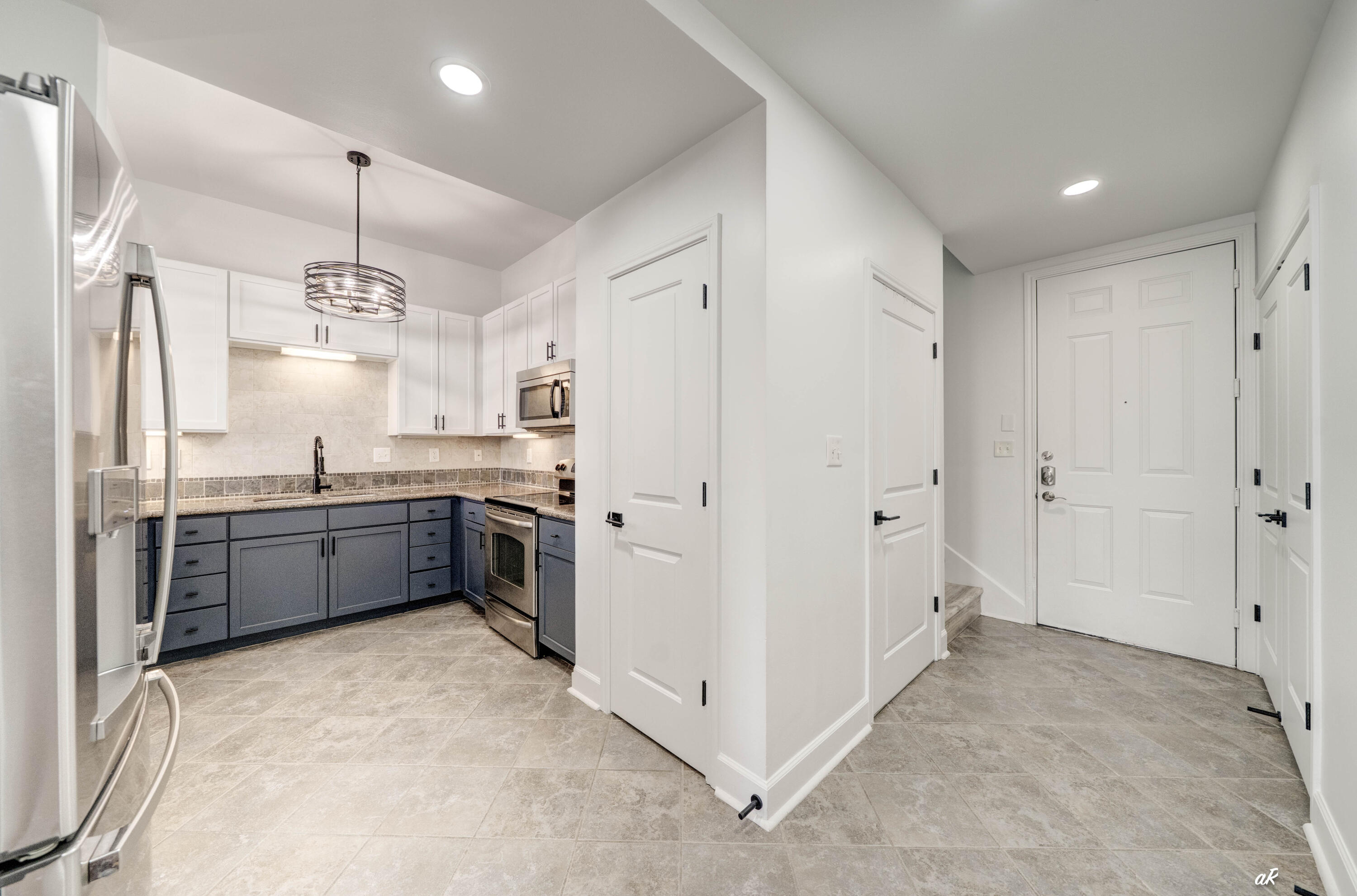 Welcome to your completely renovated Panama City condo, where modern design meets effortless coastal living. Every detail has been thoughtfully updated, creating a truly move-in-ready home with high-end finishes throughout. Step inside to discover brand-new luxury vinyl plank flooring throughout the living areas, second floor, stairs, and closets, complemented by fresh interior paint on the ceilings, walls, trim, cabinetry, and built-ins. The open living spaces are enhanced with all-new recessed lighting, updated ceiling fans, stylish light fixtures, and floor-to-ceiling double-layer blackout curtains in both the living room and primary bedroom. The beautifully updated kitchen features freshly painted cabinetry, new pendant lighting, a new flush-mount ceiling fixture, a new sink, and a brand-new refrigerator, offering a clean, modern space that's perfect for everyday living or entertaining. The primary suite has been transformed into a luxurious retreat with dual sinks, elegant chandelier lighting, custom vanity trim, and a professionally designed walk-in closet complete with furniture-grade built-ins, custom shelving, double-hanging storage, black closet rods, and dedicated his-and-hers organization. The hall bathroom has also been tastefully updated with a new sink, vanity enhancements, and a new toilet, while both bathrooms feature brand-new toilets.  Additional upgrades include a custom office with a newly added interior window opening, trim detail, and additional electrical outlets, along with new shoe molding throughout, professionally repaired drywall, and meticulous finish work that gives the entire condo a fresh, polished feel. From top to bottom, this extensive renovation leaves nothing to do but move in and enjoy everything Panama City has to offer. Whether you're looking for a full-time residence, vacation getaway, or investment opportunity, this turnkey condo offers exceptional style, quality, and value in one beautifully updated package.