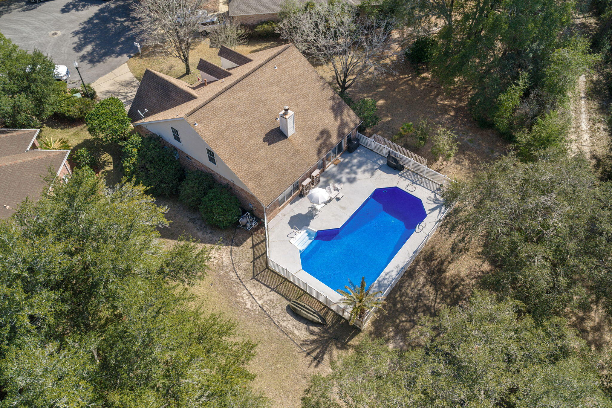 Pool Home in the Highly Desirable Gated Parkwood Estates in Niceville! Tucked away at the end of a quiet cul-de-sac and backing to a protected natural preserve, this 4-bedroom, 2.5-bath home offers privacy, vaulted ceilings, and a stunning 30,000-gallon pool designed for entertaining.
Located in one of Niceville's most desirable gated communities, this beautifully maintained home features abundant natural light, soaring ceilings, and a loft overlooking the main living area. Expansive windows frame the backyard oasis, allowing sunlight to reflect off the pool and fill the home with warmth.

The primary suite is conveniently located on the main level in a split floor plan design and overlooks the pool with serene preserve views. It has a large walk-in closet.  The en suite bath offers a soaking tub, separate walk-in shower, and an oversized double vanity that wraps the corner layout for maximum space and functionality.  Upstairs, all guest bedrooms are thoughtfully positioned for privacy, making this layout ideal. 
Step outside to your private retreat featuring a 30,000-gallon pool ranging from 4 to 10 feet deep, perfect for swimming, entertaining, and relaxing. The surrounding deck provides ample space for outdoor seating and gatherings. With no rear neighbors and mature trees throughout the lot, the setting is peaceful and private.

Additional highlights include a brand new hot water heater and a 2019 HVAC system. This is a rare opportunity to own a private pool home in Parkwood Estates, one of Niceville's most sought-after neighborhoods.