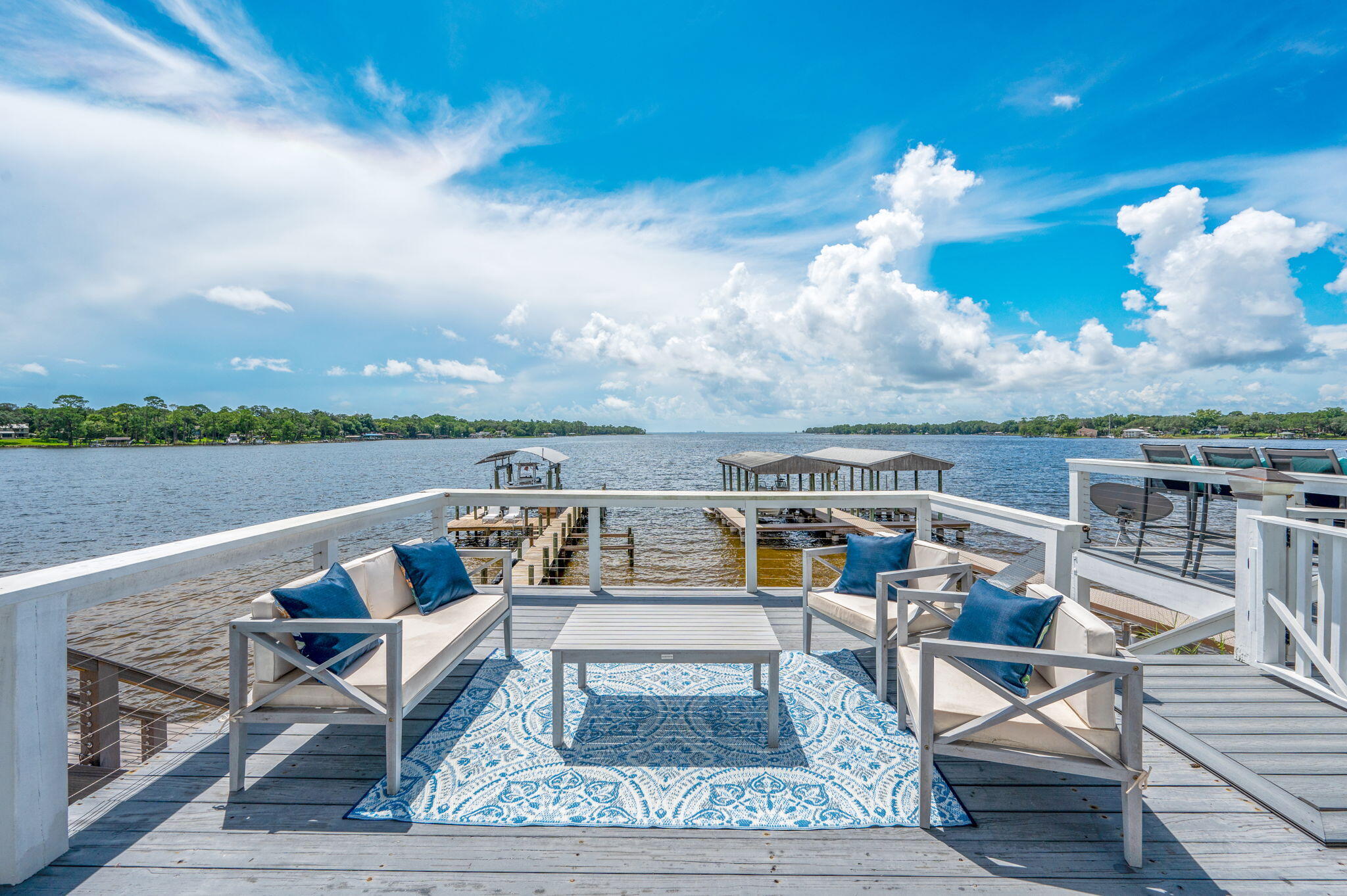 Short-term Rentable! Rare 25 feet of deeded water frontage. NO HOA, Own your own water frontage.  Live the dream in this gorgeous, upgraded direct bay-front home offering breathtaking water-views, floor-to-ceiling windows, and a front-row seat to daily dolphin sightings!  3 bedrooms and 2.5 baths. Brick and hardy-board exterior, and remodeled throughout, this home is show-stopping.  Vaulted entry, open-concept living areas, trendy black and white kitchen with premium finishes, granite, extra cabinet space and full pantry.  Master is a suite, with jetted tub, dual vanities, perfect views, and bonus sitting area- for peacefully moments. Both additional bedrooms have en-suite bath access. Sellers will consider adding Chair-lift on stairs with acceptable offer for accessibility.