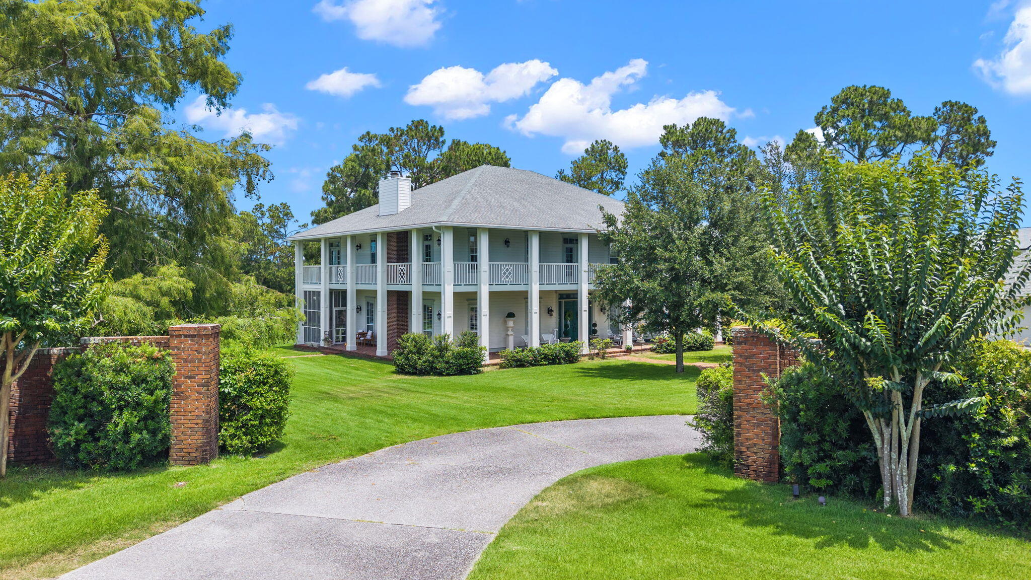 Tucked behind the gates of Bay Point, a grand Southern, Colonial plantation-style estate set on nearly an acre of manicured grounds has been designed for families to enjoy for generations to come. A stunning, two and a half homesites in total overlooking the 6th green, this home truly impresses! 

At almost 4,700 square feet and sitting on one of the largest homesites in the community, you'll enjoy .87 acres overlooking a tranquil pond and private pool. A showstopper of acreage, views and privacy, this is a property that earns its reputation before you ever step through the door. The full-width, wrap-around porches and balconies spanning both levels set the tone immediately: this is a home built for living and blends the indoors and outdoors seamlessly. 

Step through the grand foyer and you'll see a thoughtful design with attention to family gatherings. To the right, a private home office with a full bath and direct access to the wrap-around patio, perfect for the executive who needs a true separation between work and home, or for guests who deserve their own wing. To the left, an extraordinary living room anchors the main level entertaining experience: a room large enough for pool, ping pong and more, including a wet bar and a fireplace, soaring high ceilings, and the energy of a space that has seen it's share of neighborhood family parties! This is the room that becomes part of your family's legend. A wine room positioned across from the formal dining room speaks to the home's commitment to entertaining done properly. The kitchen has been fully renovated and nothing short of spectacular. A built-in banquette for relaxed morning breakfasts. A dedicated coffee bar. A large island with waterfall countertops. Custom cabinetry, stainless appliances, and a layout that opens directly to a cozy living area and a screened porch, keeping the cook in your family connected to the conversation. Every detail here was considered! 

Step off the screened porch and into a backyard that redefines what outdoor living at the beach looks like. The pool and spa are stunning. They're built for long summer afternoons and evenings that never seem to end. Beyond the 40' pool, nearly an acre of lush, private lawn opens up into something rare in any gated community: space. Room for pickleball, bocce ball, basketball, batting practice, or whatever your family dreams up. And at the edge of it all, your own private dock on the pond overlooking the golf course. 

Upstairs, the primary suite is a true sanctuary. Spacious, serene, and anchored by a fully appointed en-suite bath with a soaking tub, a tiled walk-in shower, and double vanities. Step through to the full-width wrap-around balcony, your own private morning retreat with coffee in hand and nothing but pond and golf course views of Bay Point. Each of the remaining bedrooms offers its own en-suite bath, giving every member of the household the kind of privacy that keeps families at peace. A flex room at the top of the stairs rounds out the upper level, equally suited as a fitness room, a playroom, a study, or whatever the next chapter of your life requires. 

This home has been well-maintained and recently had the exterior completely repainted and is stunning from the moment you drive in the gates. Living at Legend Lakes means living inside one of the most coveted communities on the Gulf Coast. Bay Point is golf-cart friendly, gated, and layered with amenities that make every day feel like a vacation you never have to leave. Point South Marina. The Bay Point Golf Club. Neon's Bar 72. The Serenity full-service spa...all on site. And when the beach calls, you are ten minutes from some of the most beautiful white sand and turquoise waters on the Florida Panhandle. Keep your boat at the Point South Marina and never get in your car to hit the water - just a short 2 minute golf cart ride to your vessel! 

This is the home where your family builds its memories and legends begin.
