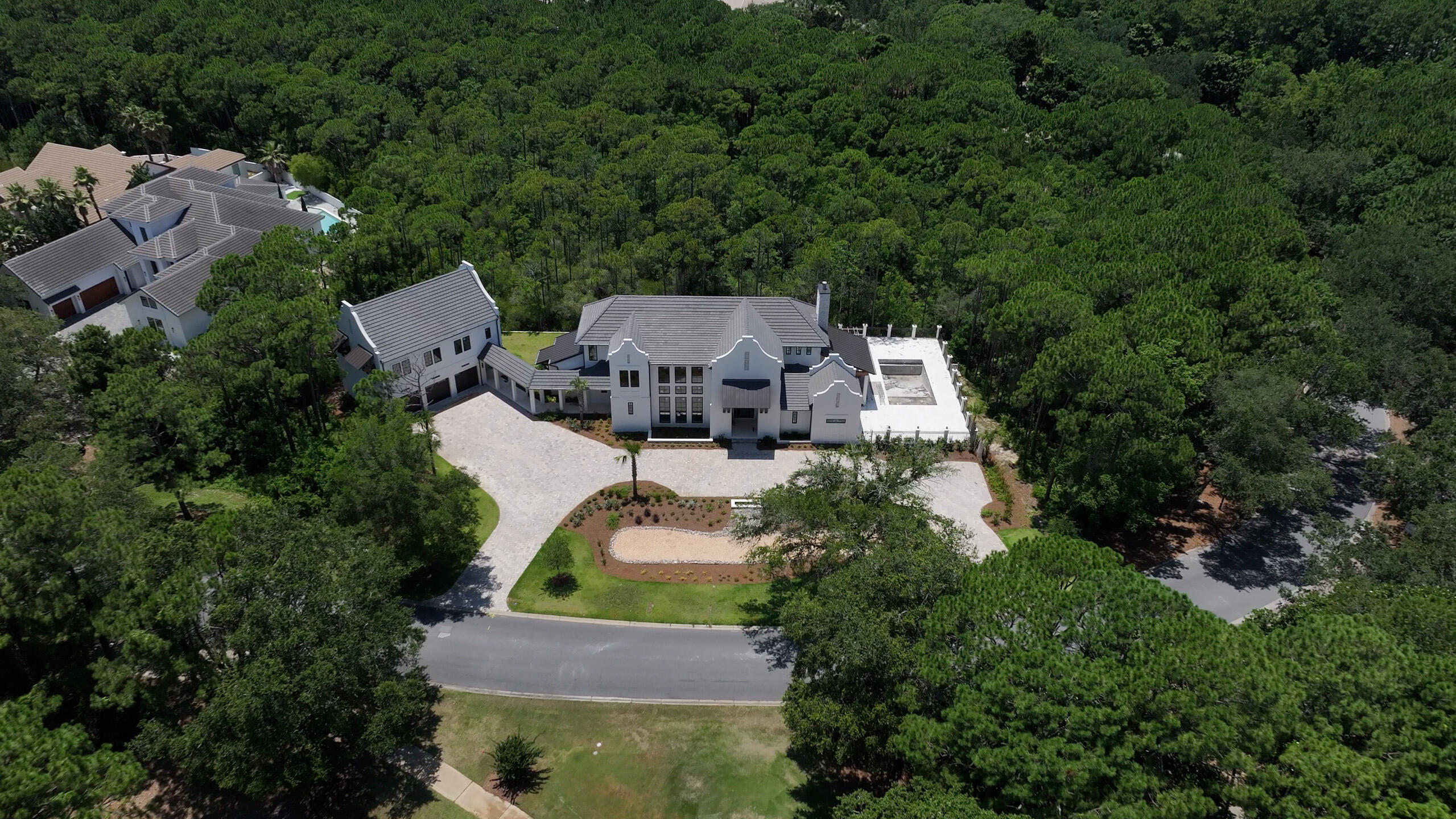 Experience unparalleled luxury in this spectacular new custom estate in the highly sought-after Regatta Bay community. Currently under construction and nearing completion, this exceptional residence showcases superior craftsmanship, timeless architecture, and the finest high-end finishes throughout. The main home offers 5 bedrooms and 4.5 baths designed for both elegant entertaining and everyday comfort. The thoughtfully designed floor plan features a grand living room anchored by a stunning gas fireplace, a formal dining room, and a chef's kitchen equipped with premium appliances, custom cabinetry, and all the bells and whistles. A massive walk-in butler's pantry provides abundant storage and prep space. The first floor includes a luxurious primary suite, a private guest suite, and a powder room. Upstairs, you'll find a spacious loft and three additional guest bedrooms. Above the detached 3-car garage is a beautifully appointed carriage house complete with 2 bedrooms, 1 full bath, a full kitchen, breakfast nook, and living room--perfect for guests, extended family, or private accommodations. Situated on more than 2 acres and backing to a serene, wooded preserve, this estate offers exceptional privacy and outdoor living. Resort-style amenities include a large swimming pool, outdoor shower, summer kitchen, and an inviting outdoor fireplace, creating the ultimate setting for entertaining year-round. Regatta Bay is a serene, gated community that seamlessly blends golf and boating, offering a lifestyle that is truly unparalleled! The essence of the Regatta Bay Lifestyle revolves around convenience, allowing residents to easily access numerous enjoyable destinations within minutes via golf cart, including the beach! Within the community, residents can indulge in golf, swimming, tennis, pickleball, parks, playgrounds, the Regatta Bay Clubhouse, Legendary Marine, and Legendary Yacht Club. Furthermore, Regatta Bay features a private road that leads directly to the Destin Commons, where an array of popular retail stores for both men and women awaits, alongside a diverse selection of restaurants, Whole Foods, Bass Pro, Lowes, an AMC movie theater, and Uncle Buck's Bowling-all easily reachable by golf cart. Regatta Bay is centrally located offering easy access to the airport and only a few miles from Northwest Florida's finest hospital. Schedule your private tour today and experience the elegance of Regatta Bay living.