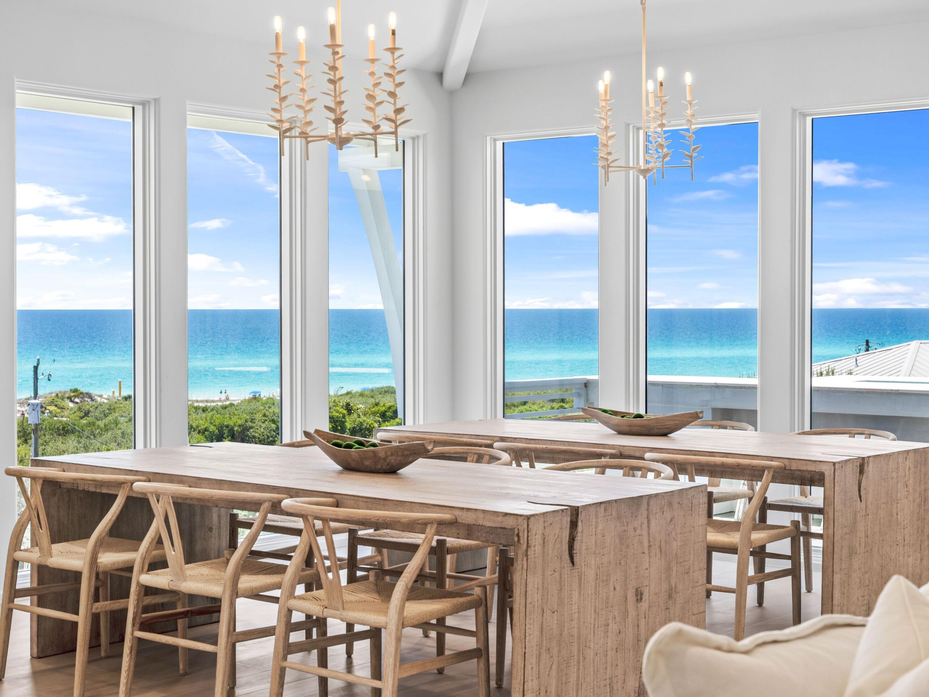 PRICED TO SELL and just steps from the Gulf, this four-level custom home in the community of Mala Beach represents a standard of construction with features rarely seen on the Emerald Coast. Built as a personal home, every material and finish was hand curated -- and it is evident throughout the residence. Spanning an immaculate 6,018 square feet with an elevator servicing all levels, there are four spacious primary suites with king beds and  two bunk rooms.  The first floor sets the coastal tone with a large open living area with Peacock paver floors and floor-to-ceiling Jeldwen windows allowing in a multitude of light.  A dining area, marble wet bar with sink and refrigerator, powder bath, laundry and connected garage which is currently being used as a game room complete this level. The second floor hosts two of the four primary suites, both with an all-marble bathroom featuring a freestanding soaking tub, rain head shower, and floating vanities, along with private balcony access. Also on this level are the two generously sized bunk rooms, each sleeping five guests across three singles and one full sized lower bunk, and each with a dedicated bathroom with large walk-in shower. The third floor delivers two additional king primary suites, both with direct balcony access and Gulf views. The bathrooms are equally impressive with freestanding tubs, oversized marble showers with ceiling-mounted rain heads, and dual floating vanities with Carrara marble countertops. Every bedroom in this home has been finished with the same uncompromising attention to detail; the only difficult decision will be choosing which one to claim. The fourth floor is the crown jewel of the home. A dramatic vaulted ceiling opens over a fully integrated living, dining, and kitchen space. The chef's kitchen anchors the room with a handcrafted La Cornue range that draws attention the moment you walk in, a paneled SubZero refrigerator, Italian-made cabinetry and honed Carrara marble countertops. The powder room on this level is finished in hand-made Moroccan Zellige tile. Euro Wall sliding doors open the entire living space to the magnificent rooftop deck complete with heated pool. In total, the home offers over 1,000 square feet of outdoor living space across all levels. Designed to embrace its stunning surroundings, the floor plan seamlessly flows from indoor to outdoor spaces, offering views of the majestic Gulf waters and the picturesque white beaches. This remarkable retreat is a must-see for the discerning buyer seeking the ultimate blend of serenity, style, and coastal charm. Mala Beach is a seven-home Gulf-front community in Inlet Beach, just steps from one of Walton County's best beach accesses and minutes from Alys Beach, Rosemary Beach, 30Avenue and all of the shopping and dining venues.