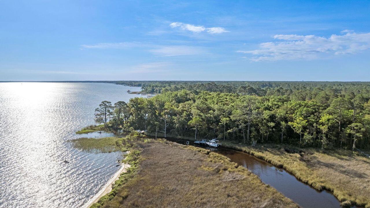 Estuary is an exclusive, gated, waterfront community in Point Washington. A Dock and Boat LIFT are in place to go along with 122 ft of water frontage. Estuary allows easy access to Grayton Beach, and all 30A has to offer. Enjoy privacy while being a bike ride away from the Gulf of America, 30A, and all the great restaurants.  Estuary boarders Point Washington State Park, where there are miles of trails/bridges for the new owner to enjoy the mature trees, and shade for hiking,biking, or just enjoying the nature.