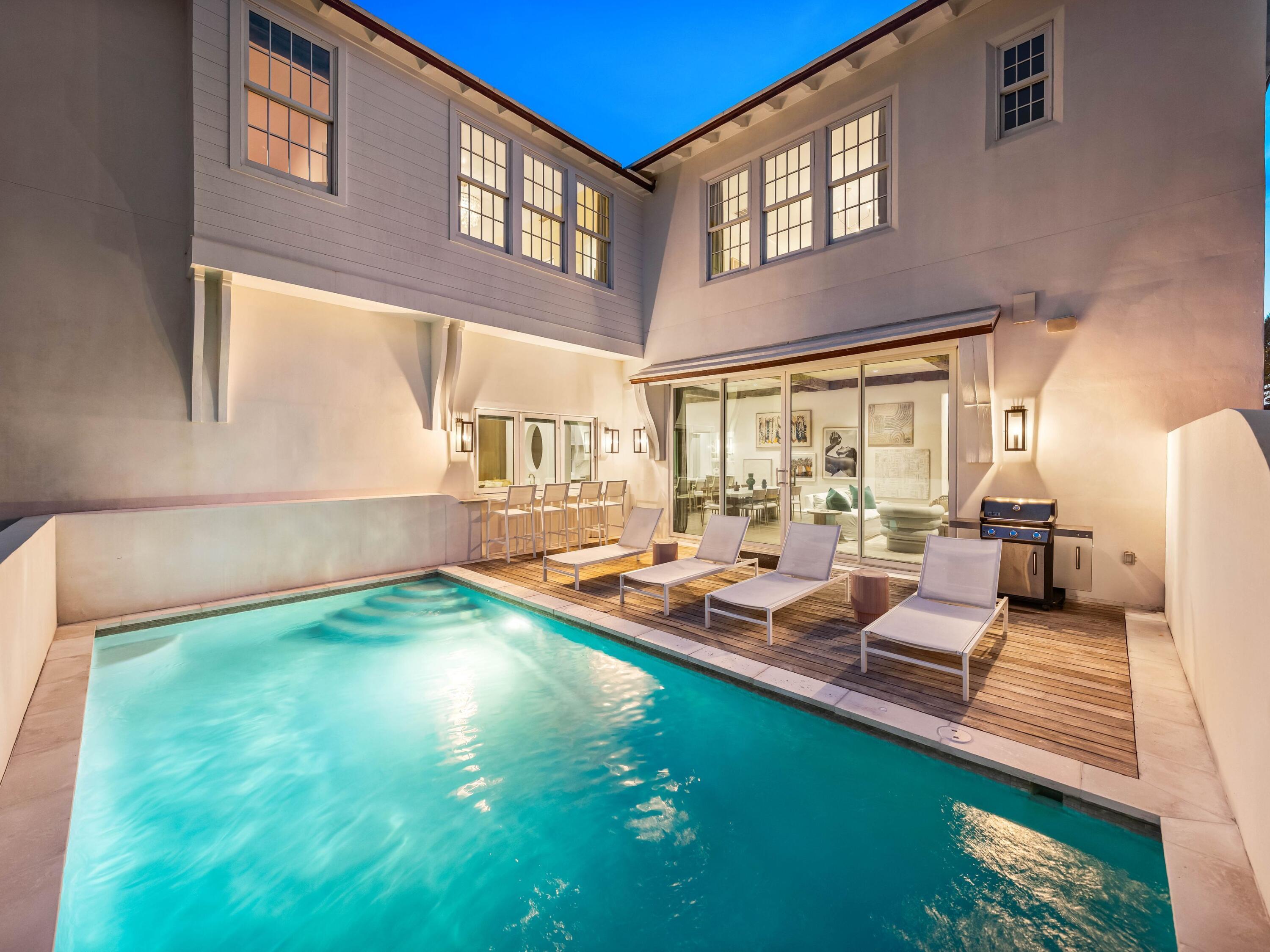 Welcome to Santimo Beach, where this 5,976 square-foot residence is among 20 exclusive properties inside the gated community.  Including dedicated beach access and built by the prestigious Benecki Homes with interiors curated by Melanie Turner this spectacular property has it all. The home's three elevator-accessible floors accommodate five bedrooms, a bunk room, five full bathrooms, and a powder bath. A staircase connects the third level to the tower, which offers panoramic views of the Gulf. Two king-size bedrooms, one with an ensuite bathroom, along with a bunk room, separate a guest bathroom, and a laundry room join an oversized two-car garage with a Tesla charging station on the ground floor. The emphasis on indoor-to-outdoor living is evident once you walk upstairs, where an open-concept living area connects to an elevated deck featuring chaise lounges and a heated pool.  Accordion windows fully retract at the outdoor bar, creating a pass-through between the pool deck and a casual dining area with a wet bar. Designer cabinets conceal a range of gourmet kitchen appliances, including a Liebherr refrigerator, Thermador freezer, and Asko dishwasher. Luxurious marble accents and a custom vent hood highlight the Wolf range. A waterfall countertop serves as a striking centerpiece on the kitchen island, with bar seating that transitions to an additional dining space.
The nearby scullery neatly contains another Asko dishwasher, beverage center and wet bar.  The second floor also includes a powder bath, a media room and a double queen-size ensuite bedroom. An additional living area on the third floor creates a total of three distinct living spaces for owners and their guests to enjoy. The grande primary suite includes a luxurious bath retreat featuring a walk-in shower and soaking tub plus spacious closet. A separate light-filled room is the perfect spot for an office or yoga studio. An additional king-size ensuite plus the second laundry room complete this level. This residence boasts multiple living areas, a pool deck meticulously designed for entertaining, elegantly appointed bedrooms, and a prime location within one of the most secluded gulf-front enclaves on 30A. Within its vicinity, you can enjoy both grandeur and functionality, conveniently situated just a short distance from the pristine beach. Santimo Beach is a gulf-front community that is surrounded by the vibrant new urbanism communities of Rosemary Beach and Alys Beach. This gated retreat provides its residents with an unparalleled level of privacy amidst the vibrant social scene that permeates the nearby town centers. These town centers offer a diverse array of shops, restaurants, and events, catering to the diverse interests of their residents.