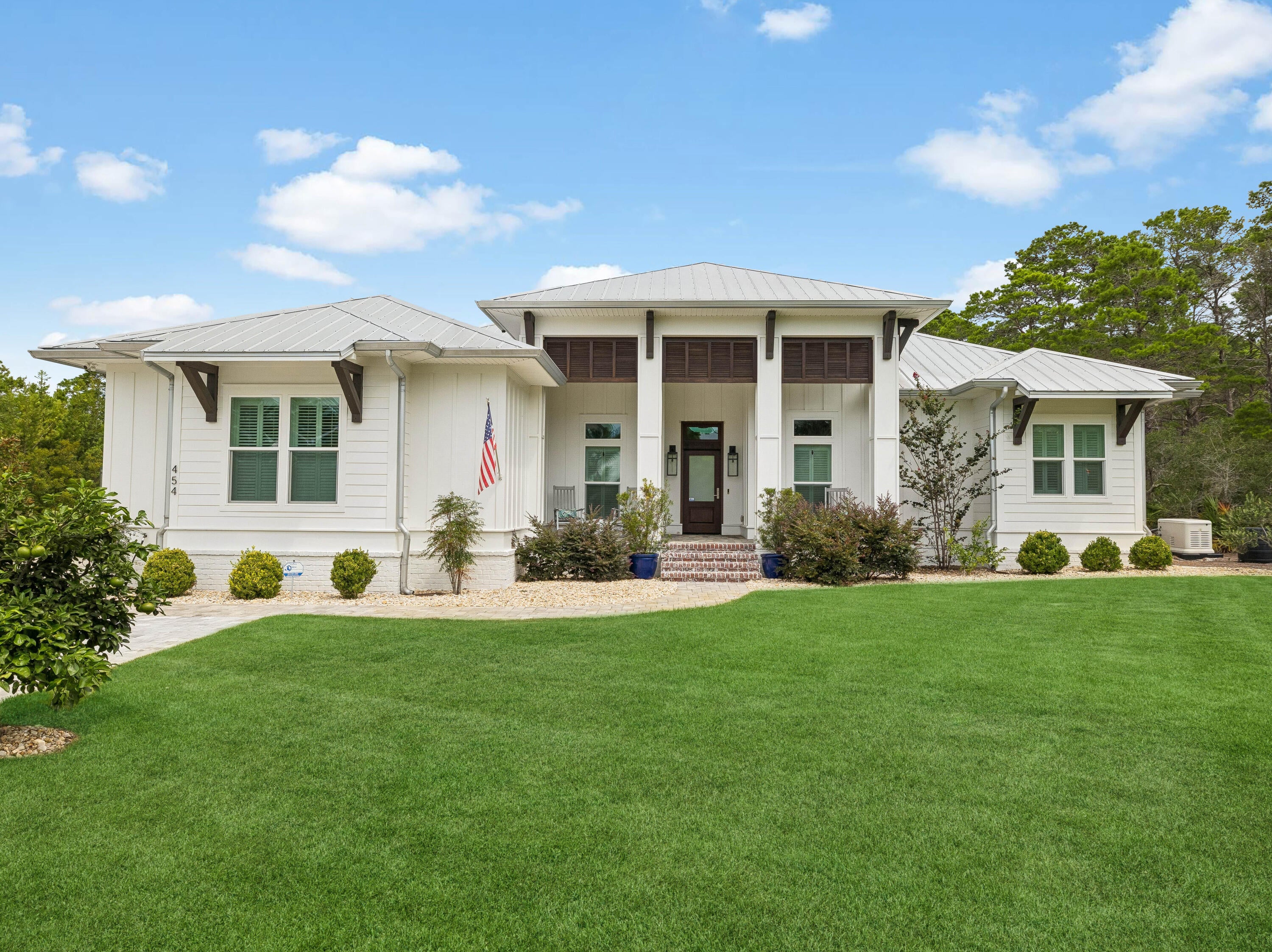 The property backs directly to a state-protected forest that cannot be developed, giving the backyard a level of privacy that is exceptionally rare along 30A, all while remaining just moments from Gulf Place restaurants, shops, and entertainment, Ed Walline Beach Access, and the sugar-white beaches of 30A.

Since purchasing the home, the current owner has invested strongly into thoughtful upgrades inside and out. The living room ceiling was raised to 12 feet and finished with wood beams, creating a dramatic, light-filled gathering space. The kitchen was reimagined with an expanded island, farmhouse sink, gas range, and a custom walk-in butler's pantry with a beverage refrigerator, complemented by a new refrigerator and range installed in 2025. Both secondary en suite bathrooms were fully renovated with tiled walk-in showers in place of tubs, and the entire interior was freshly repainted.

The outdoor living experience is equally impressive. A spacious covered porch with added gas fireplace, television, and living area overlooks the private backyard. There, an expansive pool, spa, extended paver deck, and artificial turf lounge area create a resort-like setting framed by mature pines and the protected forest beyond. Professional landscaping, including new turf, sod, and thoughtfully relocated shrubs and river rock completes the grounds front and back. An exterior storage shed offers convenient space for gardening tools and beach gear, keeping the garages free for vehicles. This is a rare opportunity to own a fully updated, move-in-ready home in one of 30A's most private settings, featuring the natural buffer of protected forest that cannot be developed.