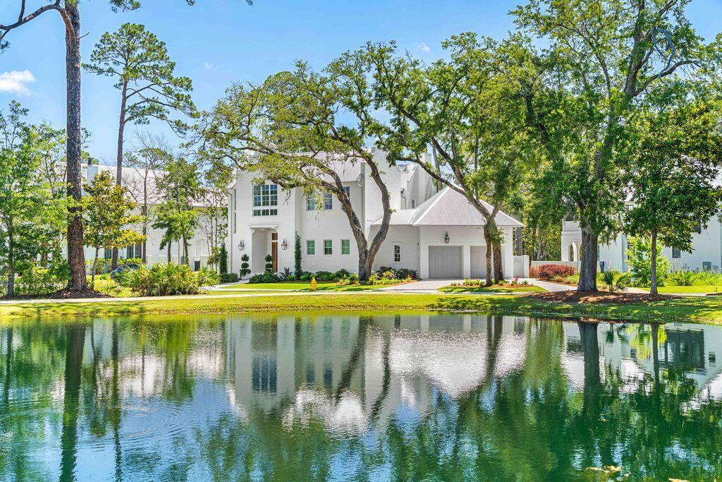 Home is where the heart is, and you'll quickly fall in love with Churchill Oaks. Nestled along Hogtown Bayou on the scenic Choctawhatchee Bay, this exclusive waterfront community offers over half a mile of shoreline and a private deep-water marina with boat slips. A rare opportunity exists to purchase separately a deeded 35-foot boat slip featuring a boat lift, providing convenient access to Choctawhatchee Bay and the Gulf beyond. 

This elegantly designed home is nestled among the beautifully landscaped grounds of Churchill Oaks, awaiting your arrival.The residence is offered fully furnished with an exquisite collection of designer-selected furnishings and refined décor, thoughtfully curated to complement the home's sophisticated coastal aesthetic. Upon stepping into the foyer, you'll immediately appreciate the home's exceptional architectural beauty and thoughtful design. From the soaring ceilings and natural stone flooring that extend throughout the first floor to the elegant mirrored wet bar and refined custom finishes, every detail has been carefully curated to create an atmosphere of timeless sophistication and comfort.

The seamless flow of the living spaces enhances both everyday living and entertaining, while abundant natural light highlights the home's exquisite craftsmanship. The kitchen is a chef's dream, featuring a Wolf six-burner gas range with griddle, separate refrigerator and freezer, a convenient coffee station, stunning quartzite countertops, and an impressive 12-foot island that serves as the perfect gathering place for family and guests alike.

Just off the kitchen, you'll find a spacious butler pantry designed for both convenience and entertaining. This well-appointed space includes a second dishwasher, microwave, warming drawer, additional sink, and beverage refrigerator, making it easy to host large gatherings while keeping the main kitchen beautifully organized and functional.

Step into the spacious living room and unwind by the inviting fireplace, beautifully framed by expansive windows that flood the space with natural light and offer tranquil views of the surrounding landscape. Just beyond, the rear porch provides a peaceful retreat for relaxing or entertaining while enjoying the beauty of nature.
Take the elevator to the second floor, where wide-plank white oak flooring adds warmth and elegance throughout. This thoughtfully designed level features a spacious sitting area, a convenient breakfast bar, a laundry room, a private office with a fireplace, and three additional bedrooms.

The home offers two luxurious primary suites, each highlighted by soaring 12-foot vaulted ceilings, creating a light and airy retreat. An additional guest bedroom provides comfortable accommodations for family and visitors.

The main primary suite is a true sanctuary, featuring a spacious walk-in closet and a beautifully appointed ensuite bath with dual vanities, a soaking tub, and a separate walk-in shower, offering the perfect place to relax and unwind at the end of the day.
Ideally situated near the community boardwalk, the home offers convenient access to the clubhouse, fitness center, resort-style pool, and private marina, allowing you to fully embrace the exceptional waterfront lifestyle Churchill Oaks offers.