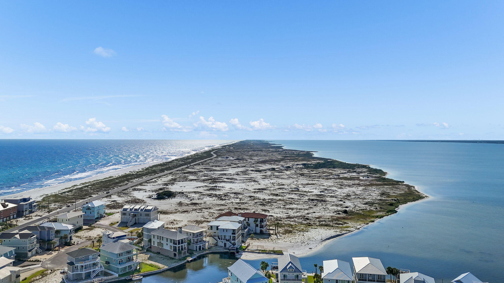 The Ultimate Navarre Beach Retreat -- Luxury Vacation Home & Investment Opportunity
Imagine owning a place where mornings begin with Gulf views, afternoons are spent on the water or along sugar-white beaches, and evenings end gathered around the fire pit as the sun sets over Santa Rosa Sound. Whether envisioned as an exceptional vacation home, luxury short-term rental investment, or a one-of-a-kind coastal residence, this extraordinary property in gated Sailmaker Cove offers the space, setting, and lifestyle to create unforgettable experiences for owners and guests alike.
A spectacular new outdoor patio and fire pit overlooking the Sound creates the perfect setting for sunset gatherings, cocktails with friends, or quiet evenings beneath the stars. With generous gathering spaces, multiple private bedroom suites, expansive outdoor areas, and a remarkable waterfront backdrop, the property also presents potential for intimate weddings, retreats, or special-event use.
This is the Navarre Beach lifestyle at its best. Spend the day fishing from the Gulf Coast's longest fishing pier, snorkeling the reefs, boating, paddle boarding, deep-sea fishing, reading a book beside the water, or simply relaxing on the sugar-white sands of the Gulf. Navarre Beach is treasured for its laid-back atmosphere and extraordinary natural surroundings, with Gulf Islands National Seashore helping preserve miles of pristine coastline and the uncrowded character that makes this area so special. A scenic drive through the National Seashore also connects you to Pensacola Beach, with additional dining, entertainment, and island activities just minutes away.

Set within the prestigious gated community of Sailmaker Cove, this custom-built waterfront residence seamlessly blends timeless coastal design with elevated Mediterranean elegance. Surrounded by the serene landscape of Gulf Islands National Seashore and offering forever views, the setting alone makes this property truly exceptional.

From the moment you arrive, the home makes an immediate impression with its elegant white stucco exterior, Spanish cement tile roof, and beautifully designed wrought-iron balcony overlooking the Gulf and its pristine sugar-white beaches.

Spanning more than 3,794 square feet, this meticulously curated 4-bedroom, 5-bathroom residence was designed for both sophisticated living and effortless entertaining.

The first floor features an inviting open-concept layout that flows naturally into a chef-inspired kitchen appointed with high-end custom solid-wood cabinetry and stone countertops. The open gathering spaces provide an ideal setting for entertaining family and friends while enjoying breathtaking views from the comfort of home.

A spacious first-floor bedroom suite with a luxurious private bath provides exceptional accommodations for guests. Tile and hardwood flooring complement an impressive collection of custom details throughout the residence, including imported sinks, a dramatic cement wine-display wall, and exquisite 19th-century European stained glass incorporated above bedroom doors and throughout select walls. These distinctive elements bring warmth, history, and character rarely found in coastal construction.

Upstairs, the expansive primary suite is a true private retreat featuring a comfortable sitting area, custom built-ins, and a private balcony showcasing breathtaking water views. Two additional guest bedrooms, each with an en-suite bath, enjoy picturesque views of Santa Rosa Sound and the surrounding protected landscape, providing privacy and comfort for family and vacation guests.

Even the garage has been thoughtfully designed for the coastal lifestyle, with high ceilings, generous storage, and dedicated space for a golf cart, beach equipment, paddleboards, and everything needed for days spent enjoying the island.

The outdoor living spaces are among the home's most captivating features. The new waterfront patio and fire pit overlooking Santa Rosa Sound transform the backyard into an incredible extension of the home. Gather around the fire as the sky changes color over the Sound, enjoy morning coffee by the water, watch dolphins pass by, entertain family and friends, or simply settle in with a good book and enjoy the peaceful surroundings. From sunrise adventures to sunset gatherings, this is a setting designed to be experienced.

Just across from a peaceful, less-crowded stretch of Gulf beach, the location offers the rare opportunity to enjoy both the Gulf and Santa Rosa Sound. Sailmaker Cove residents also enjoy a refreshing community pool and the privacy of a gated enclave surrounded by some of Northwest Florida's most beautiful natural scenery.

Whether your vision is an ultimate family vacation home, luxury short-term rental investment, primary residence, or extraordinary coastal escape, this remarkable Sailmaker Cove property offers something increasingly difficult to find: space, privacy, spectacular water views, beach access, exceptional outdoor living, distinctive architecture, and an authentic Navarre Beach lifestyle--all in one unforgettable setting.
