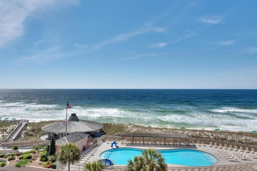 Jetty East is a Gulf front Gated 6-story midrise with under building parking located on the beautiful sugar sand beach in Destin, Fl. The location is unique as it is located on Holiday Isle (Gulf Shore Drive) which ends at the New Norriego Point Park.  Norriego Point Park is surrounded by the East Pass on one side and Destin Harbor on the other. Gulf Shore drive has a bike or walking path. The jetties of the east pass make a great spot to snorkel or fish from the jetties. Jetty East is one of the few condos to offer covered parking. Unit 517B features 2 bedrooms, 2 baths, Gulf views, and overlooks the pool and pavilion.   The unit features tiled flooring with carpeted bedrooms.  Both bathrooms have been remodeled. The Master bathroom is spacious with a walk-in shower. The guest bathroom has a shower/tub combo. The master bedroom features gorgeous views of the Gulf.   The kitchen has granite counters, subway tiled backsplash and stainless-steel appliances.  You can see the gulf from the kitchen and living room. Begin and end each day enjoying spectacular morning views of the Gulf of Mexico. Enjoy evening sunsets and seasonal fireworks from the beach. Great location for shopping, grocery stores (New Publix) and restaurants. Jetty East Amenities: 900 feet of beach, 2400 sq. ft. pool with sun deck, hot tub, beach side pavilion with charcoal grills, 3 beach accesses, tennis courts, pickleball, fitness room, kids' activities, music entertainment, shuffleboard, covered parking, 24-hour security. Remodeled owners' room with full kitchen for meetings or parties. Financing Note: 98% of STR condos are Non-warrantable/ Condotel. No conventional (government backed Fannie or Freddie) financing. The required Milestone Study and Structural Reserve Study were completed mid-summer 2025.