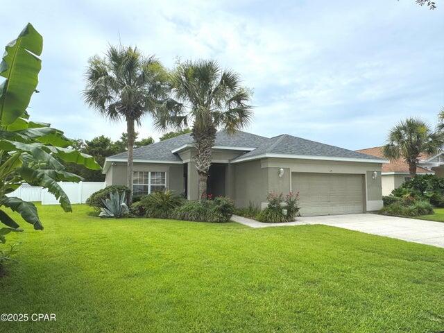 Well maintained second-home for sale in popular Palmetto Trace at Pier Park.  ceiling in the living room, plank flooring, kitchen sky light, wood kitchen cabinetry, built-in bar cabinet with cooler, security system, deluxe dimmable lighting, and surround sound throughout. The owner's suite has its own bathroom with a dual head steam shower, soaking tub, dual vanity, private toity room, and walk-in closet. The split floor plan places the second and third bedrooms at the front of the house with a full guest bathroom to share. The laundry room is complete with a full-size washer+dryer and leads to the oversized 2-car garage with storage shelving. There is a large, windowed sunroom off the living room, with portable ac, leading to an extended open back patio. The AC is brand new, exterior recently painted, roof was replaced in 2019 and there are easy to install hurricane shutters. Convenient to exciting Pier Park entertainment center, iconic 30A shoppes, highway for road trippers, and Beaches Int'l Airport. If you would prefer to purchase unfurnished, owners will clear it out. Reach out today for info and/or a tour to take a step closer to the coastal lifestyle you've always wanted!