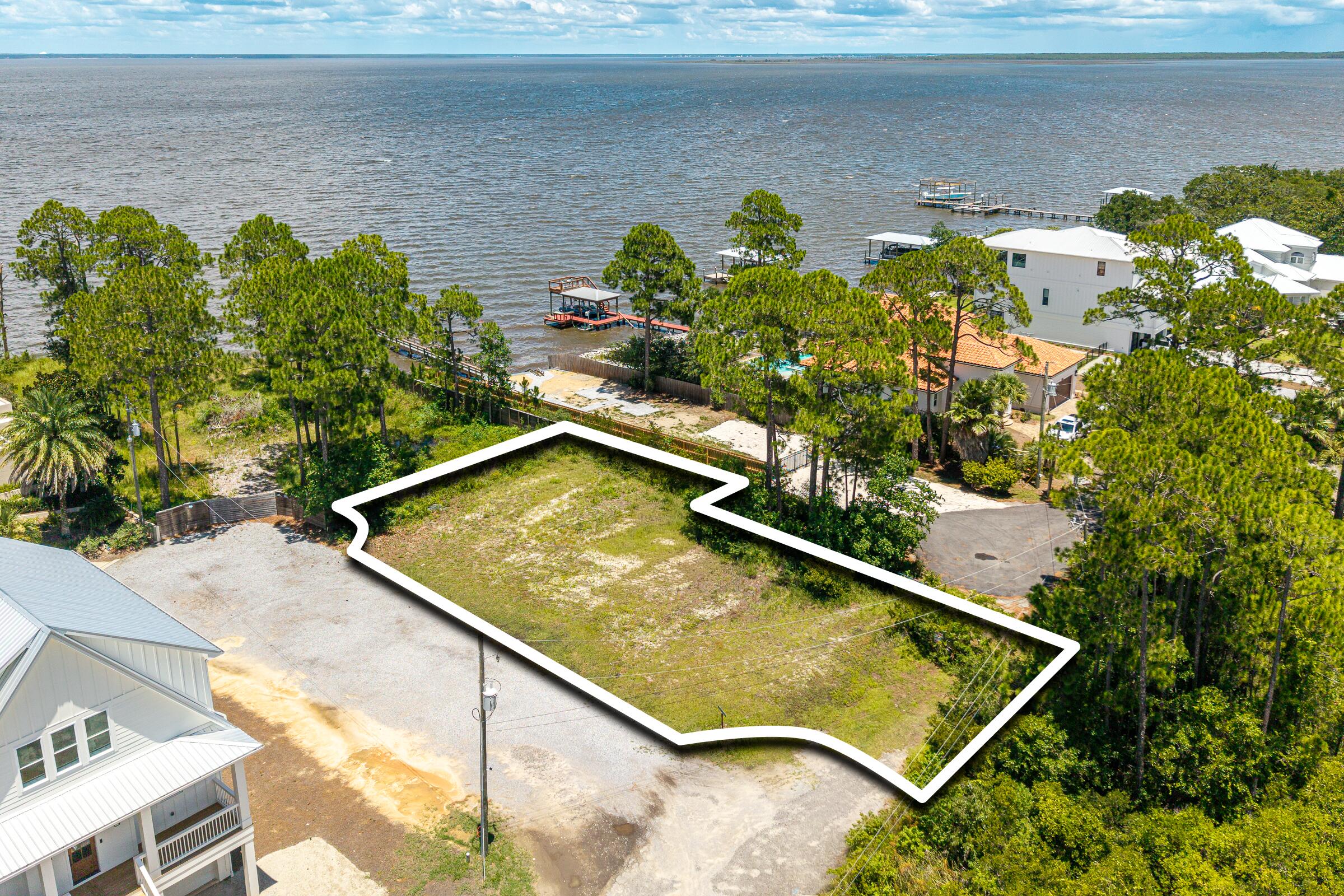 BAYFRONT VIEWS with a 10 Ft wide easement to the Bay.   Build your dream coastal retreat on this exceptional homesite in the heart of Santa Rosa Beach, offering beautiful water views and an outstanding location close to the area's renowned beaches, dining, shopping, and outdoor recreation. To help streamline the building process, the property includes a thoughtfully designed set of spec plans that can be used by the new owner, saving valuable time and helping bring your vision to life sooner.

Whether you're looking to build a primary residence, a second home, or an investment property, this lot offers an excellent opportunity to create a custom home in one of Florida's most desirable coastal communities. Enjoy the best of the 30A lifestyle with convenient access to boating, fishing, paddle-boarding, and the emerald waters of the Gulf Coast.