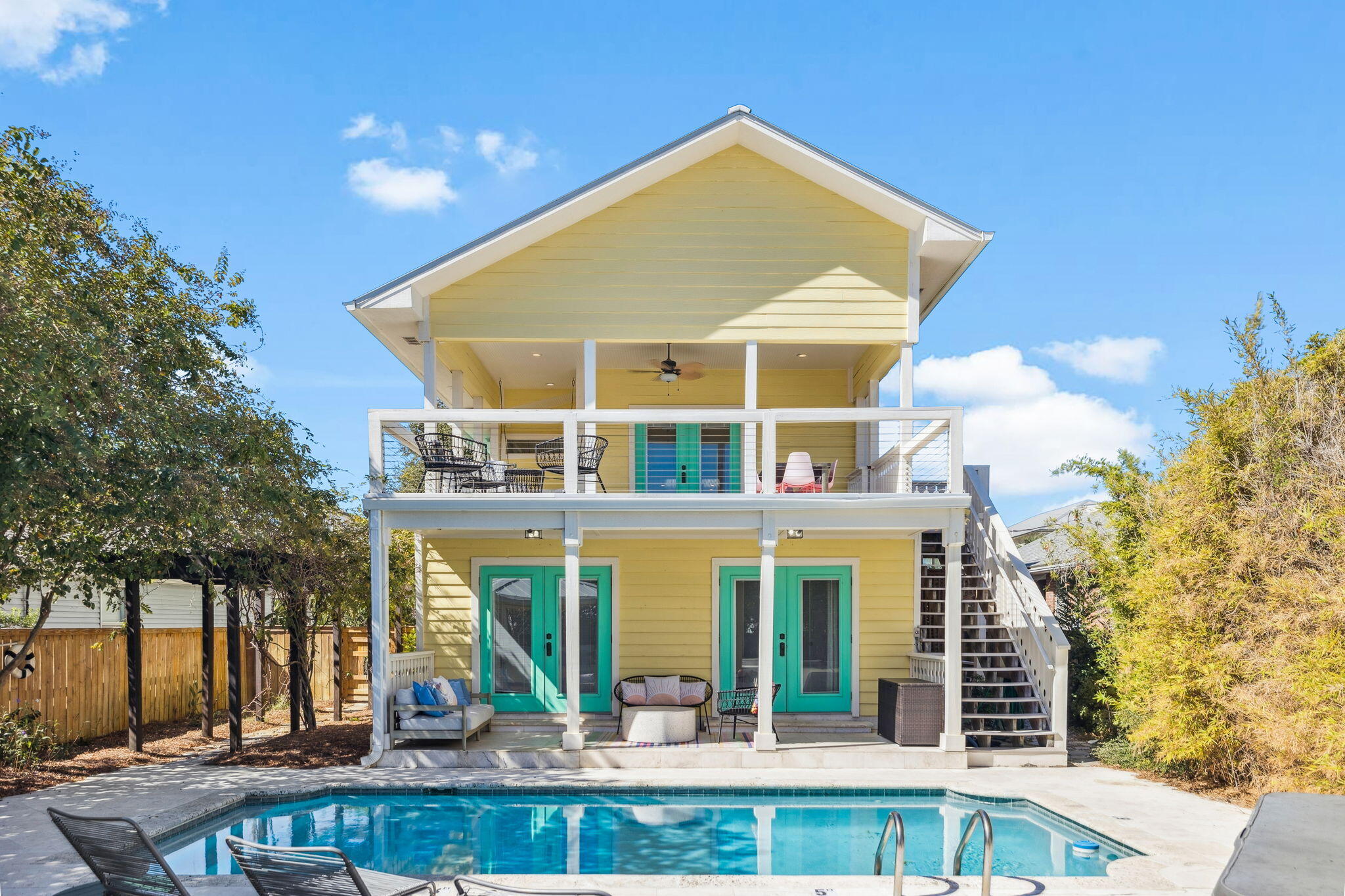 Welcome to 93 Woodward Street, a bold coastal retreat in the heart of Crystal Beach, less than half a mile from the sugar-white sands and minutes from the shopping, dining, and energy of Destin Commons. With no HOA restrictions, expansive indoor and outdoor living spaces, and a private pool and hot tub designed for true resort-style living, this home delivers the freedom, flexibility, and lifestyle that define Destin at its best.

The main living area is located on the second floor, where vaulted ceilings create a bright and open atmosphere. The living room opens to a large balcony overlooking the pool, complete with outdoor dining, a swing, and direct access to the pool deck, making entertaining easy. The kitchen is designed for both everyday living and hosting, featuring dual refrigerators, including one concealed behind cabinet paneling, abundant storage, a gas range with dual ovens, griddle, and pot filler, along with a breakfast bar, center island which conceals a wine fridge, and in kitchen dining area with booth seating. An additional balcony just off the kitchen provides even more outdoor space.

The private primary suite occupies the third floor and includes generous storage, a walk in closet located within the ensuite bathroom, dual sinks, a separate soaking tub and shower, and a private balcony with a partial Gulf view. The first floor includes the remaining four bedrooms, including a bunk room, two full bathrooms, a spacious entry area, garage access, and direct access to the pool from two of the rear bedrooms.

Outside, the home continues to impress with a covered back patio, outdoor kitchen, in ground pool, hot tub, and additional yard space beyond the expansive pool deck. A featured side courtyard connects the large paver driveway and front entry to the backyard, creating a welcoming transition between the home's indoor and outdoor living areas. Whether used as a primary residence, second home, or investment property, 93 Woodward Street offers exceptional space, privacy, and proximity to everything Crystal Beach and Destin have to offer.