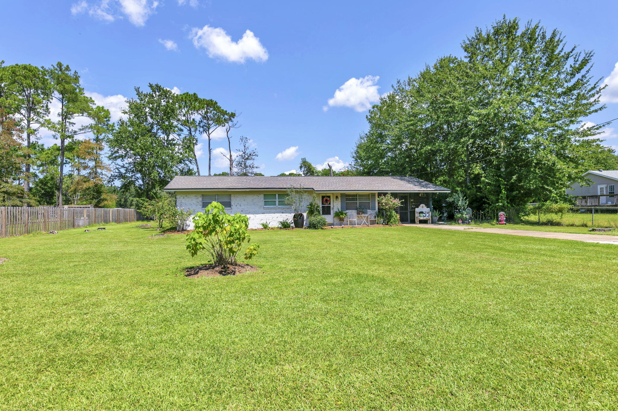 Charming 3BR/2BA Ranch on an Oversized Lot in the Heart of Freeport - No HOA! Neighboring parcel also for sale MLS listing 998290. Together, these 2 parcels equal 2 acres of prime commercial frontage along HWY 331. Discover the warmth and character of this beautifully maintained brick ranch situated on a spacious lot in a quiet, non-HOA neighborhood. Offering 3 bedrooms and 2 full bathrooms, this home blends vintage charm with thoughtful updates, creating a truly inviting and comfortable living space. Step inside to an eclectic, designer-inspired interior featuring updated flooring, fresh paint, and an abundance of natural light. The cozy living room is anchored by large windows and stylish finishes, creating the perfect gathering spot. The adjacent dining area flows effortlessly into the